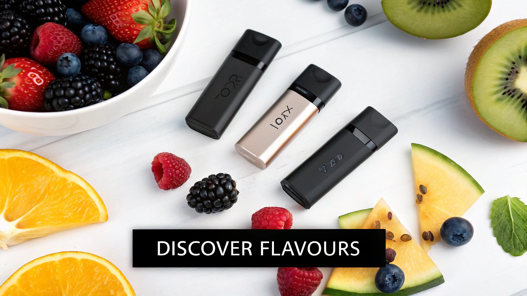 Three sleek vape devices in black and gold are surrounded by fresh fruits like berries, kiwi, orange, and melon.