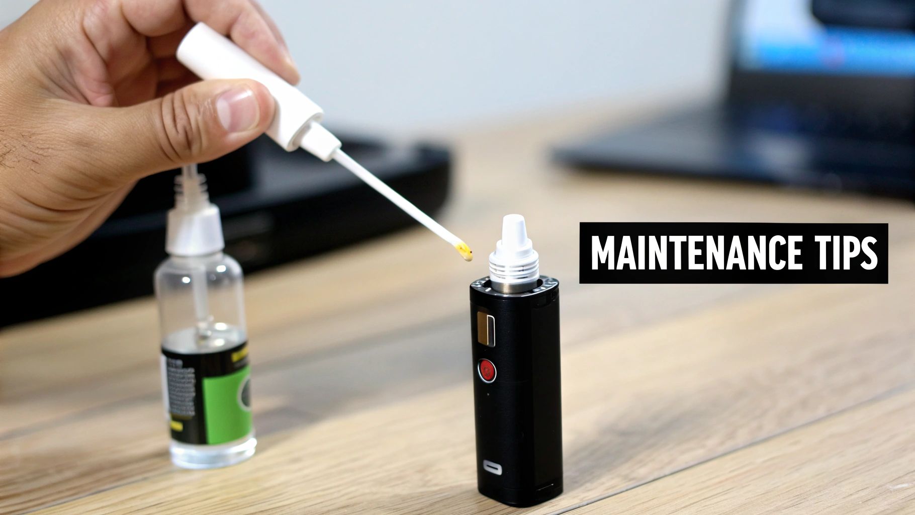 A person's hand uses a dropper to apply liquid from a bottle into a black electronic device, focusing on maintenance.