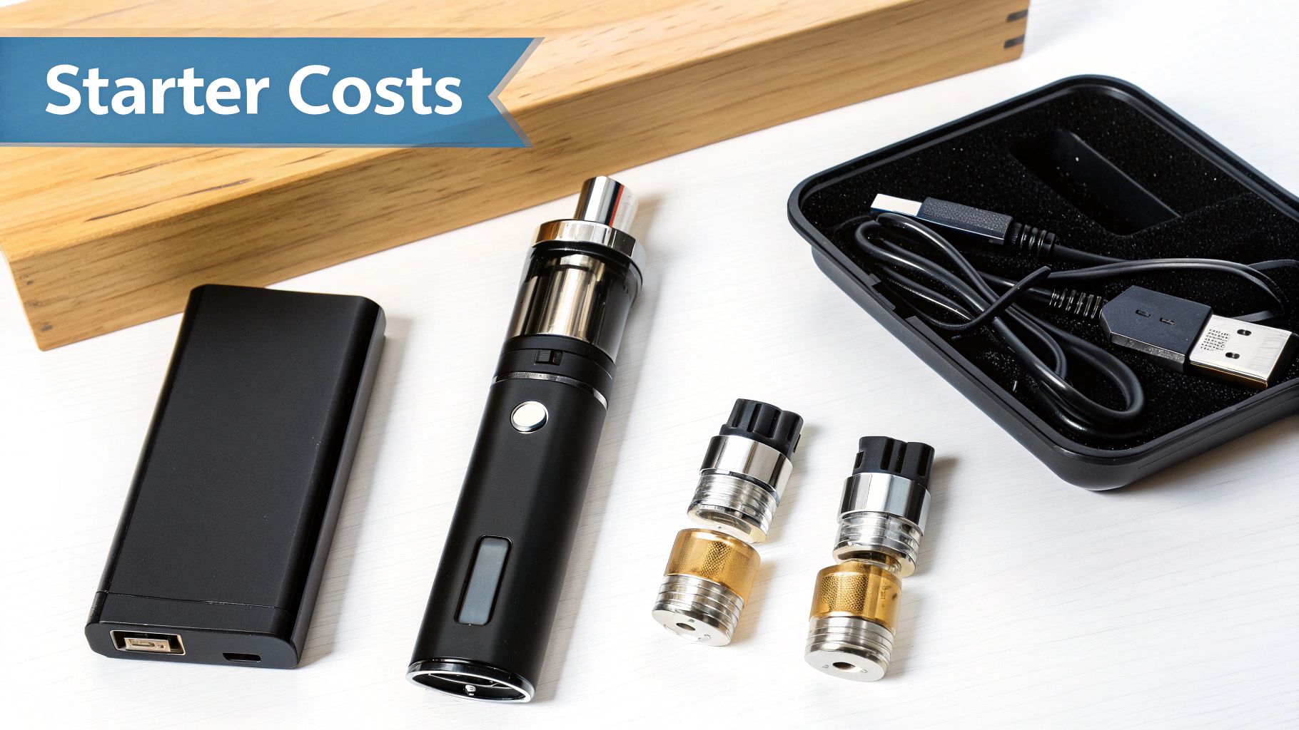 Vaping starter kit with a vape pen, battery pack, coils, and charger on a white table, showing 'Starter Costs'.