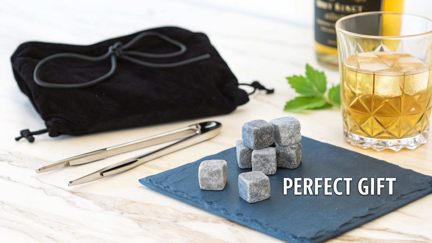 A set of whiskey stones next to a glass of whiskey on a wooden surface