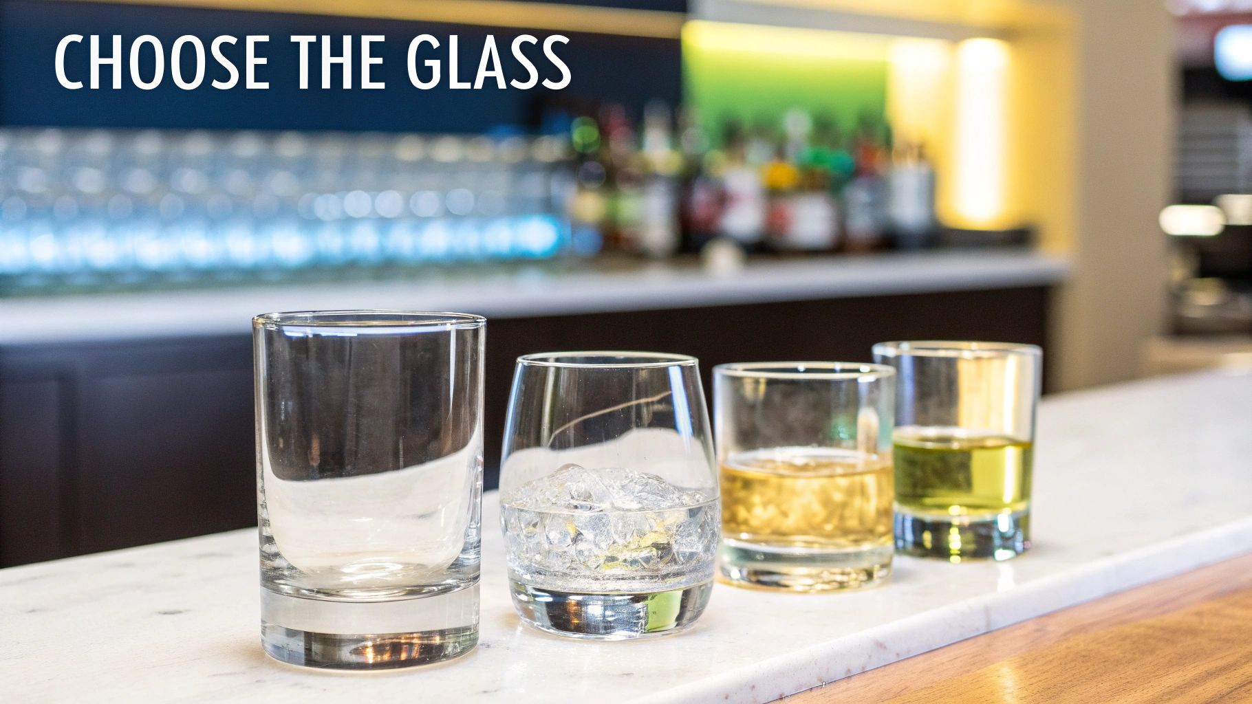 Four different bar glasses, some empty, some with drinks and ice, on a bar counter.