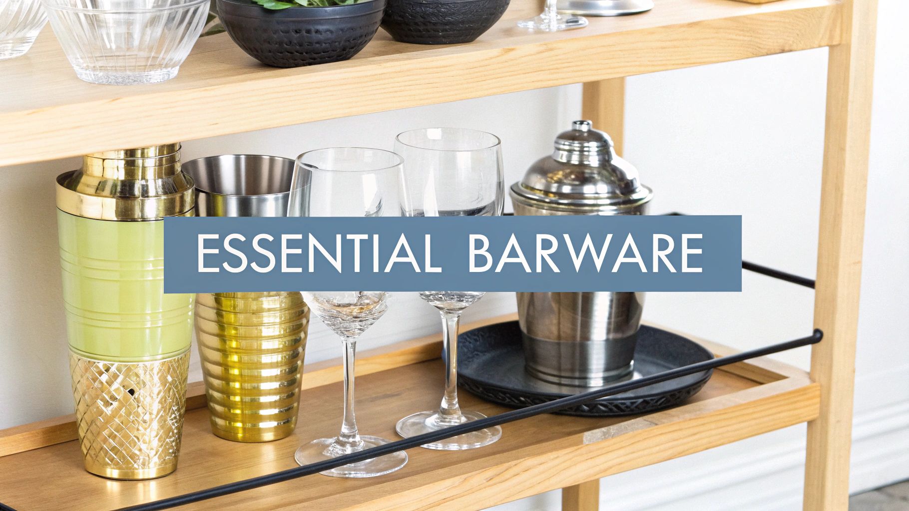 A collection of essential barware including a shaker, jigger, and glassware arranged on a surface.