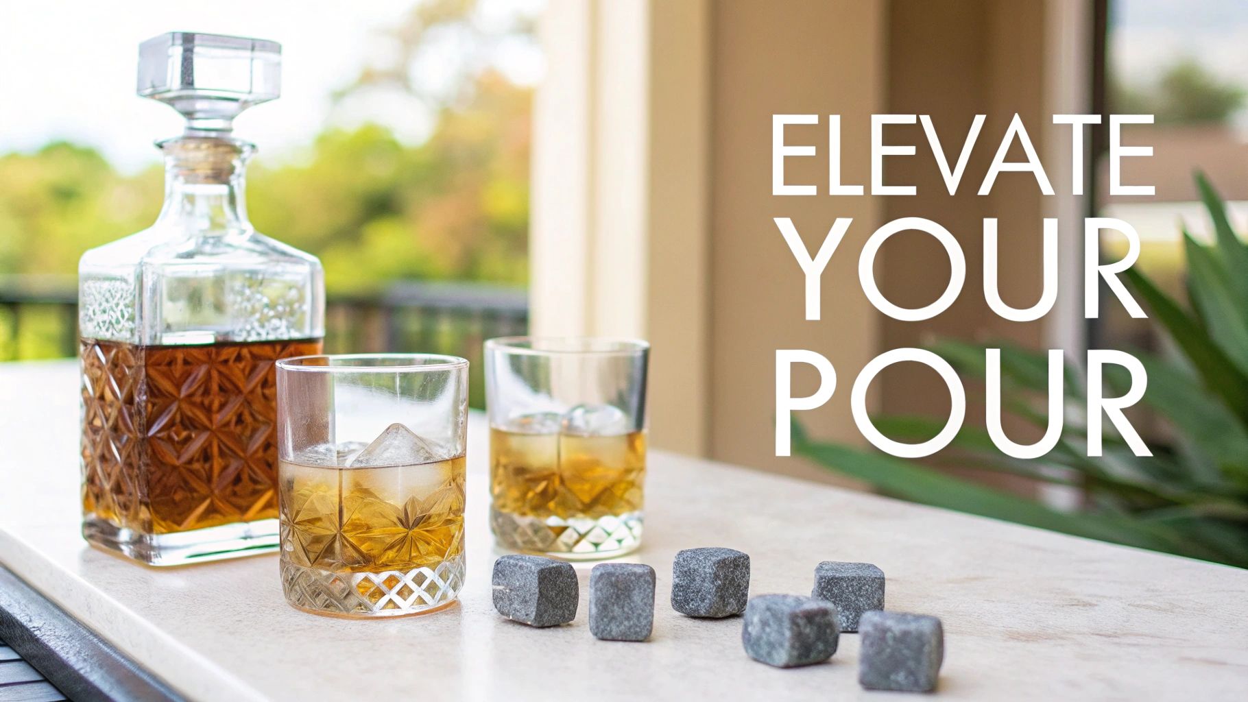A glass whiskey decanter, two glasses with ice and whiskey, and chilling stones on a table.