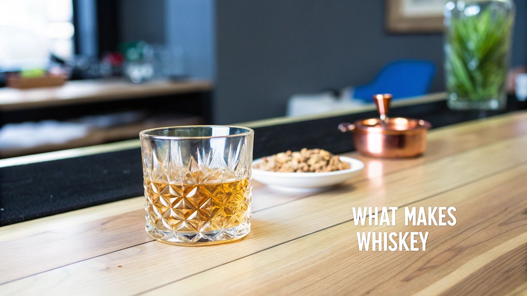 A patterned glass of amber whiskey sits on a wooden bar next to snacks, with text overlay.