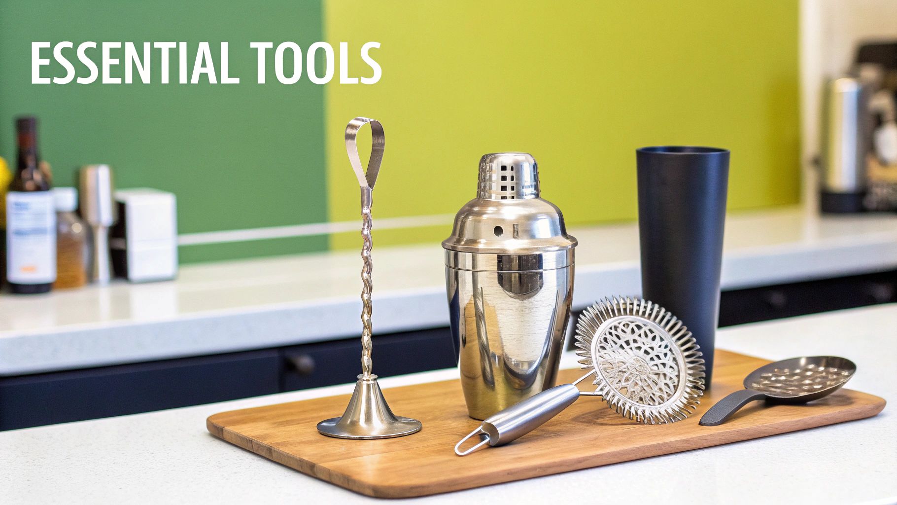 A collection of essential silver bar tools, including a shaker, strainer, and jigger, on a wooden board.