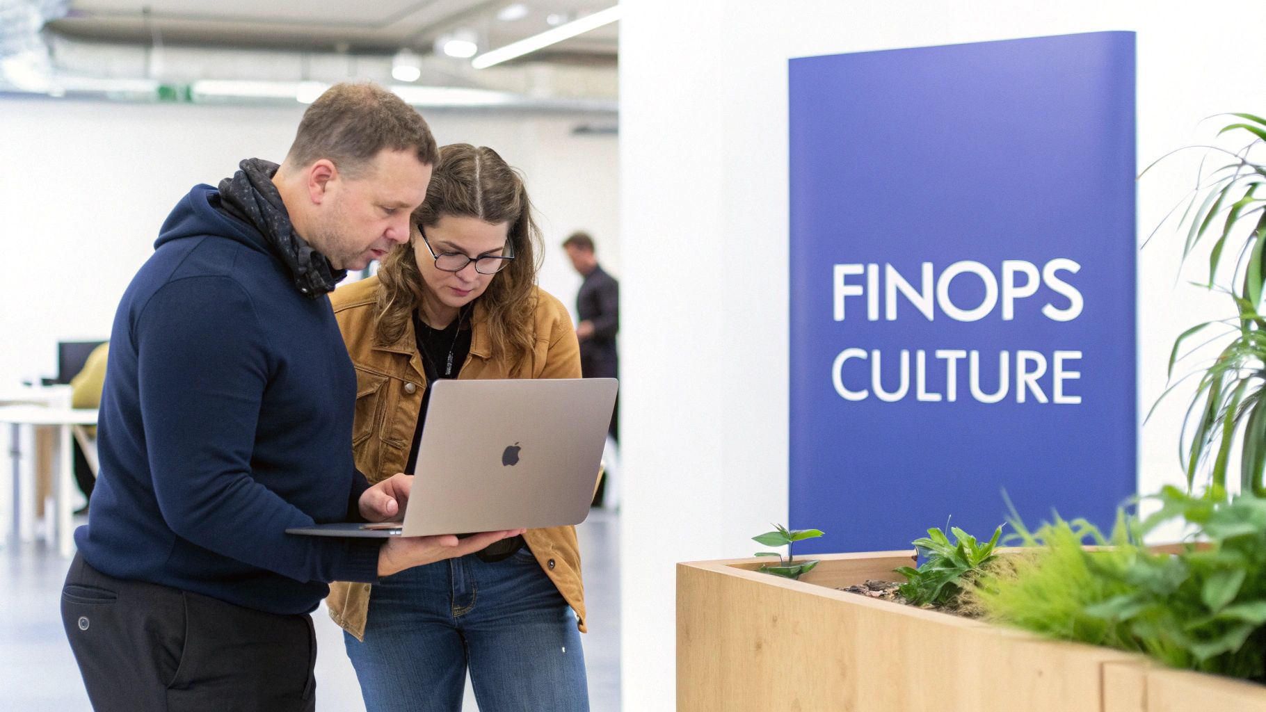 Engineers and finance professionals collaborating around a whiteboard with charts, representing a FinOps culture.
