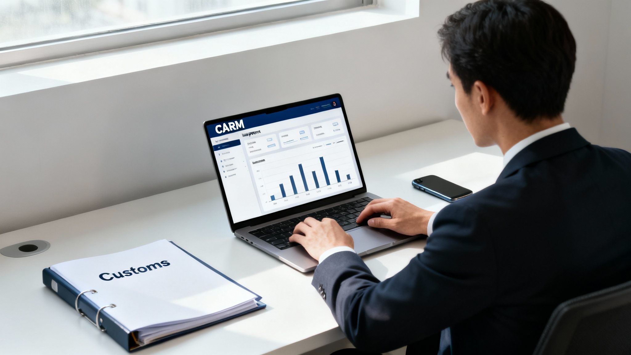 A person in a suit reviews a CARM dashboard on a laptop next to a 'Customs' binder, indicating trade compliance work.
