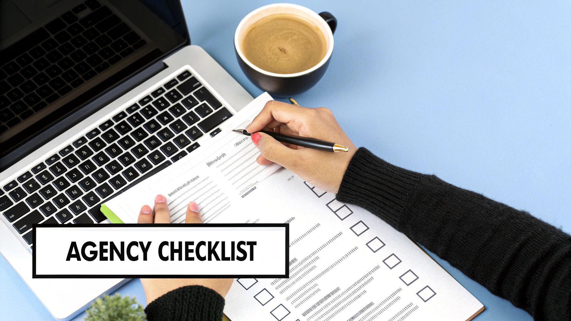 Overhead view of a person completing an agency checklist on a blue desk with a laptop and coffee.