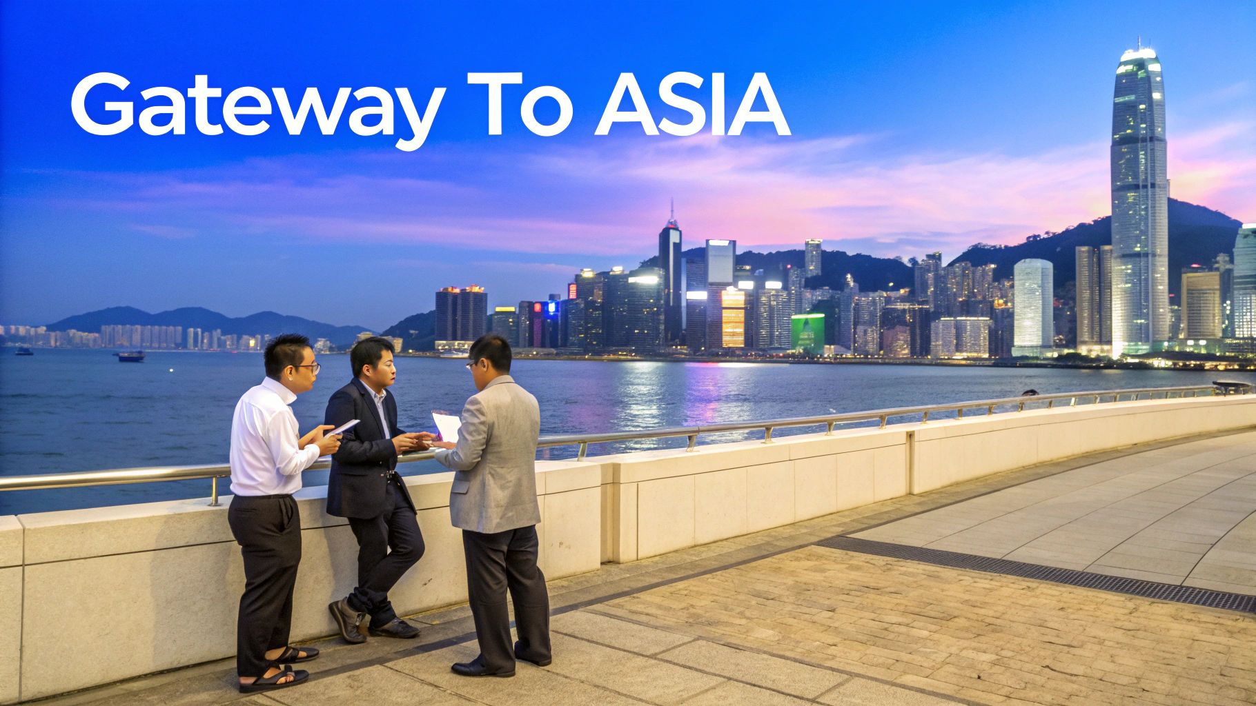 Three businessmen discuss by the waterfront with the Hong Kong skyline at dusk, text 'Gateway To ASIA' above.