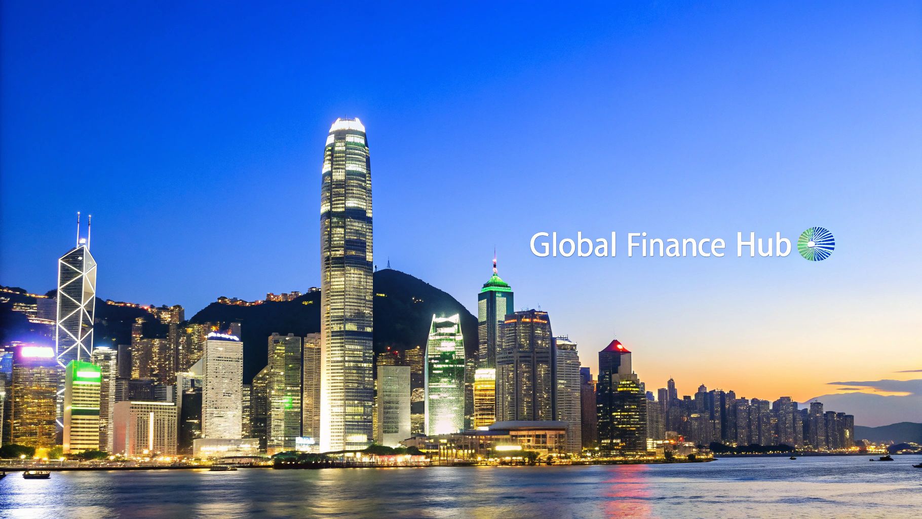 Panoramic view of Hong Kong's illuminated financial district at night with a vibrant skyline and harbor.
