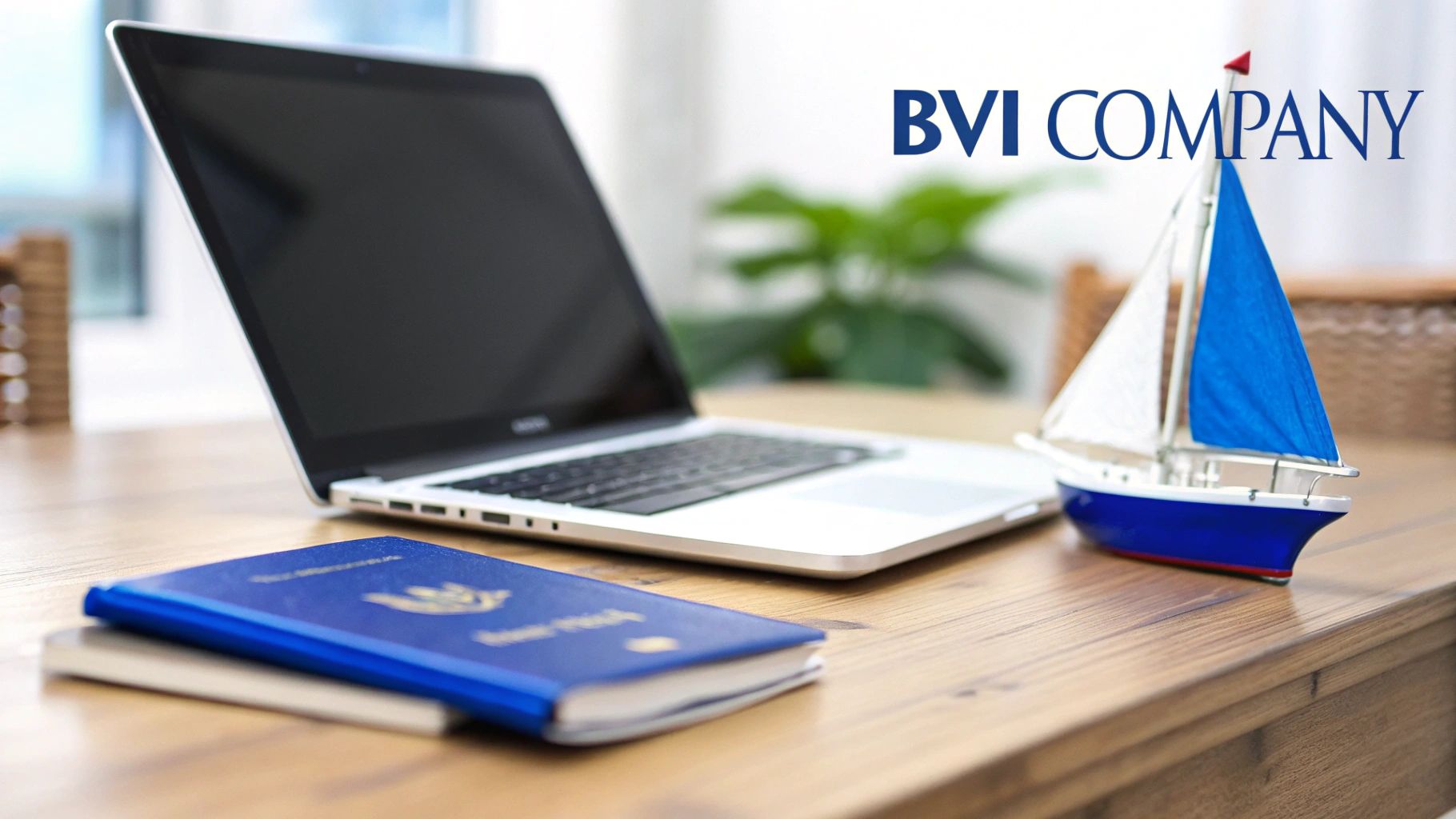 A laptop, blue passport, and model sailboat on a wooden desk with 'BVI COMPANY' text.