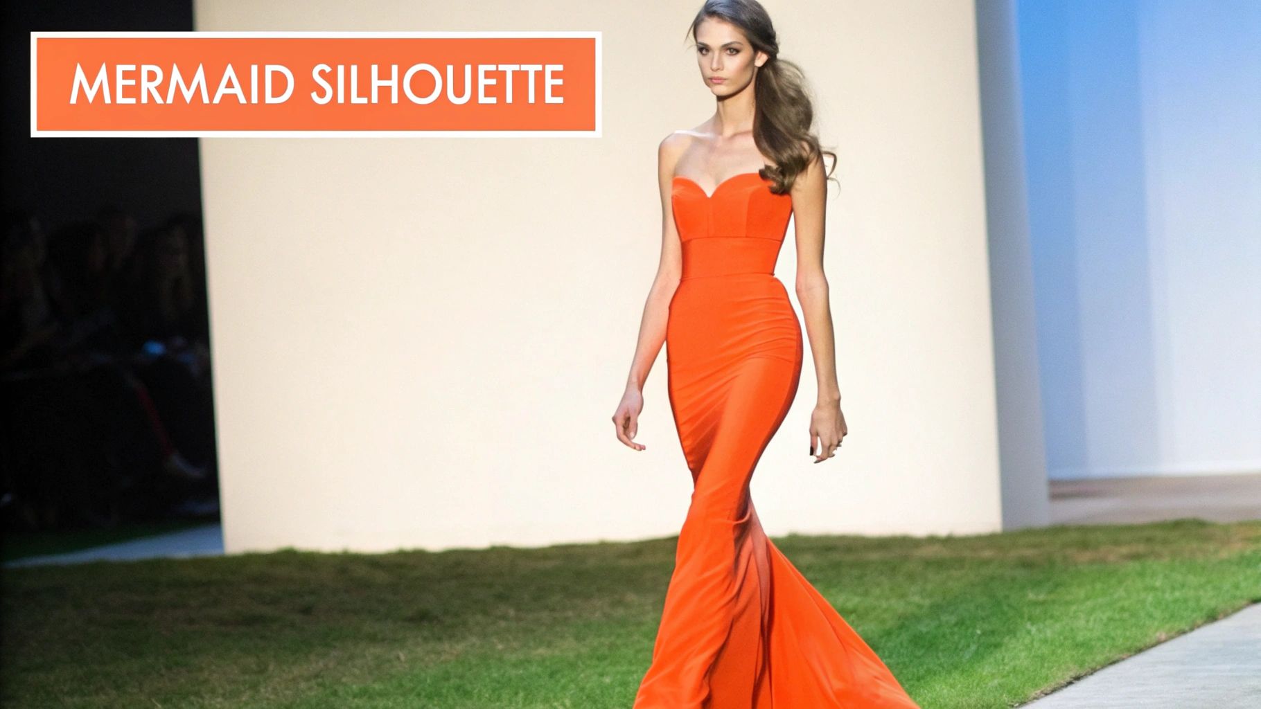 A woman wearing a shimmering, form-fitting mermaid gown with intricate beading and a dramatic flared hem.