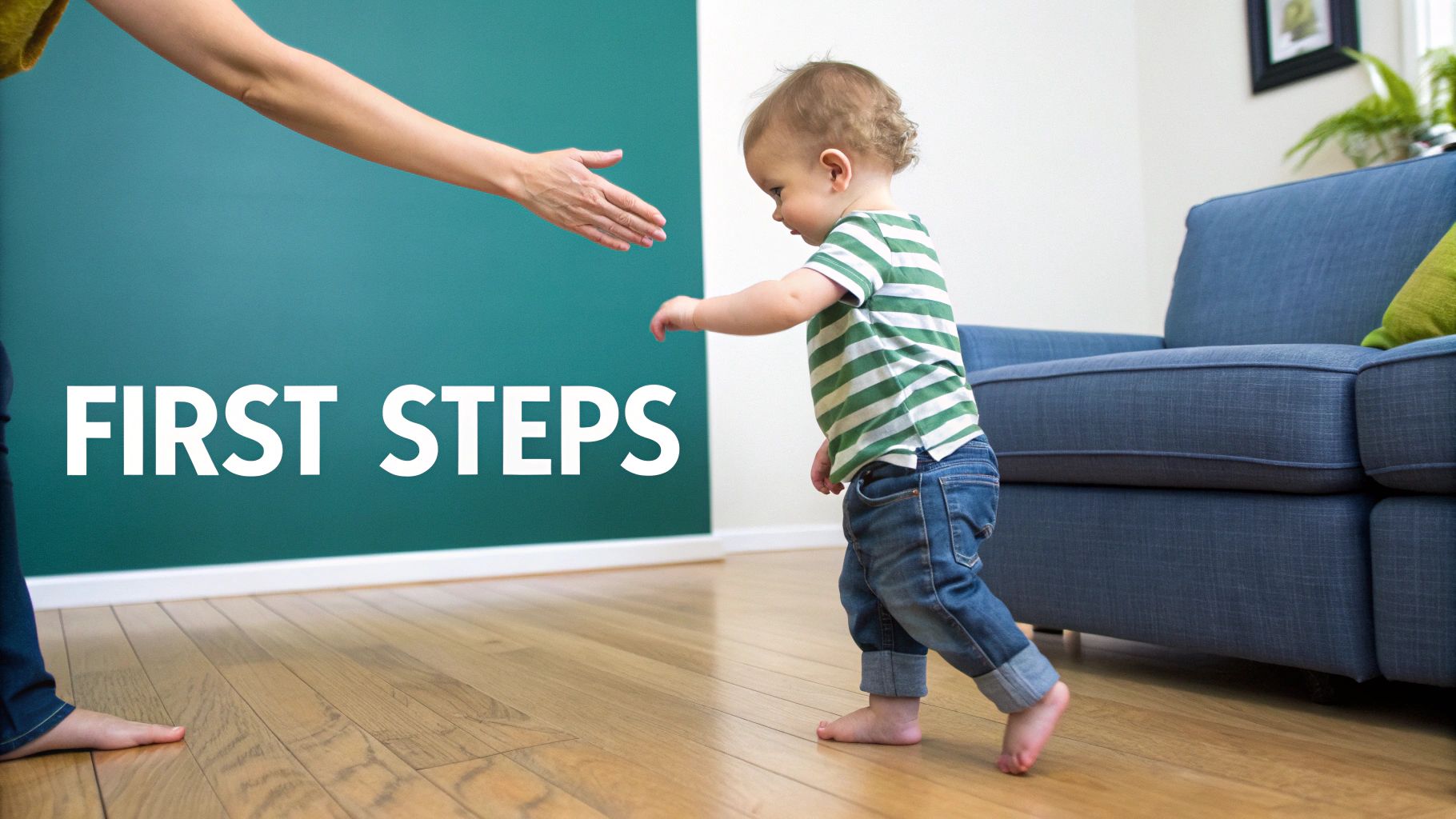A toddler in a striped shirt takes first steps towards an adult's encouraging hand.