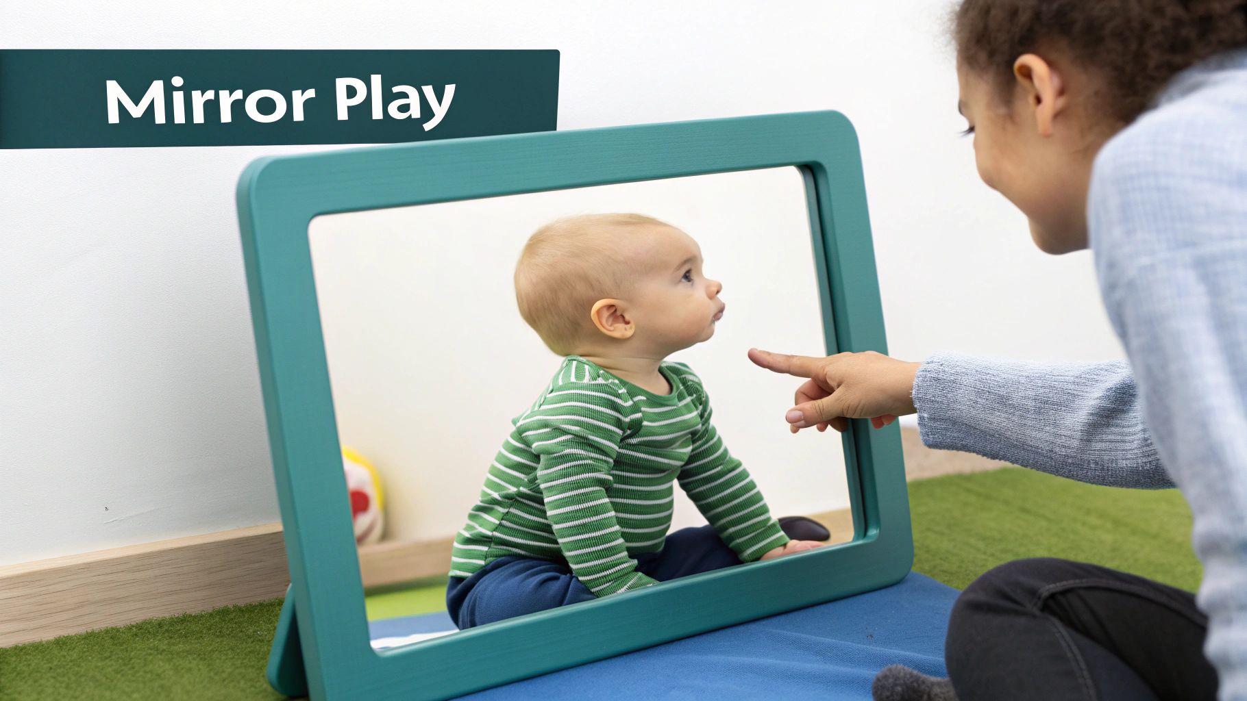 A baby in a striped shirt sits in front of a mirror, engaging in mirror play with an adult's guiding finger.