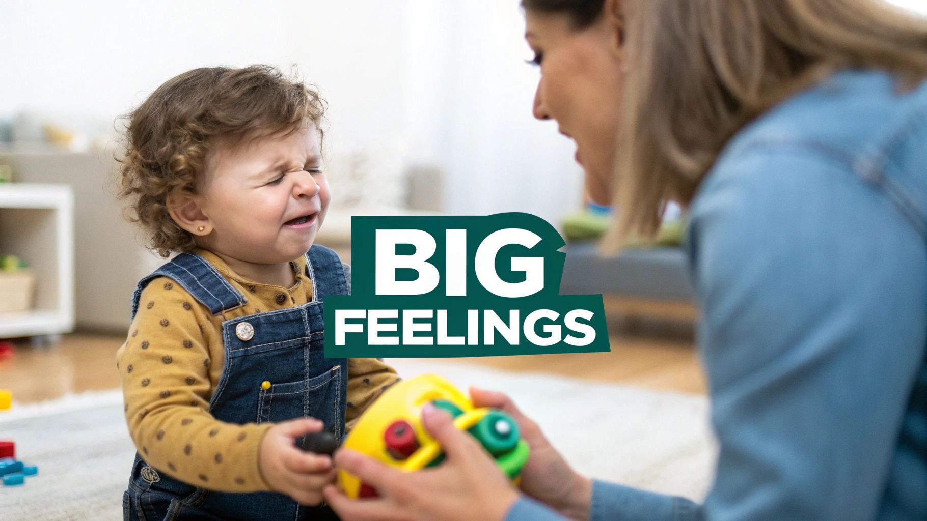 A crying toddler with curly hair is comforted by an adult holding a colorful toy, showing big feelings.