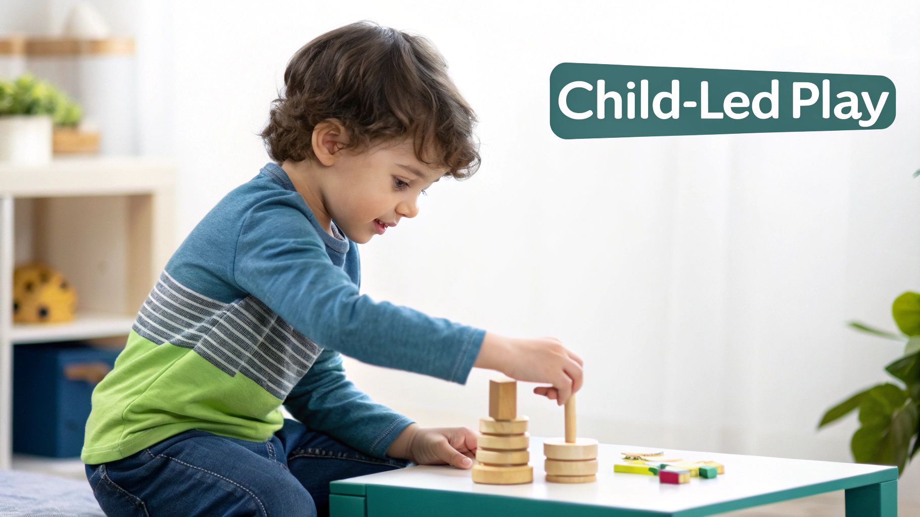 A happy toddler plays with Montessori-style wooden stacking toys at a white table.