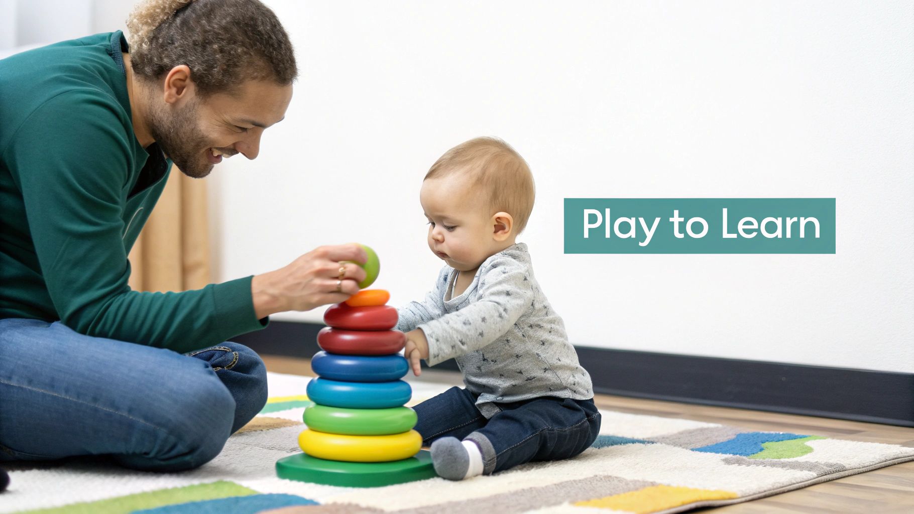 A smiling man helps a baby stack colorful rings on a toy on a patterned rug.