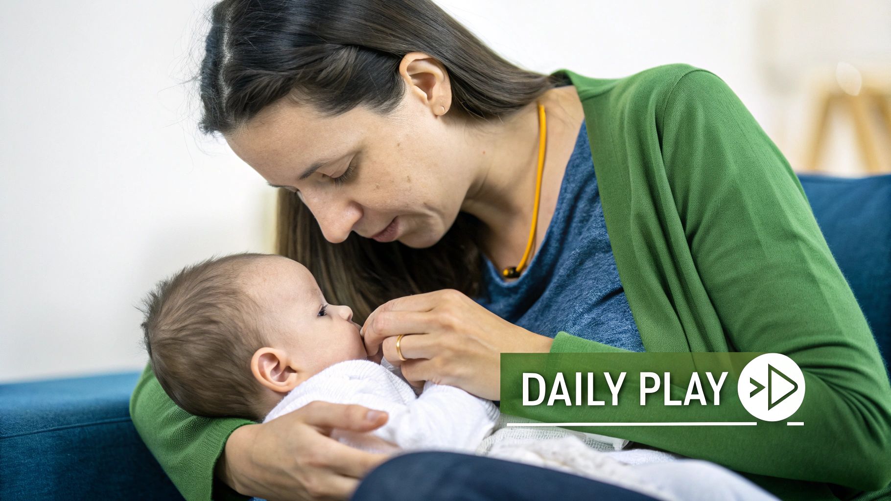 A loving mother gently interacts with her newborn baby, holding them close and smiling.