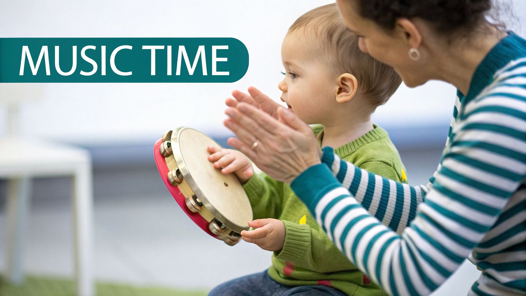 An adult claps hands with a baby playing a tambourine during 'Music Time'.