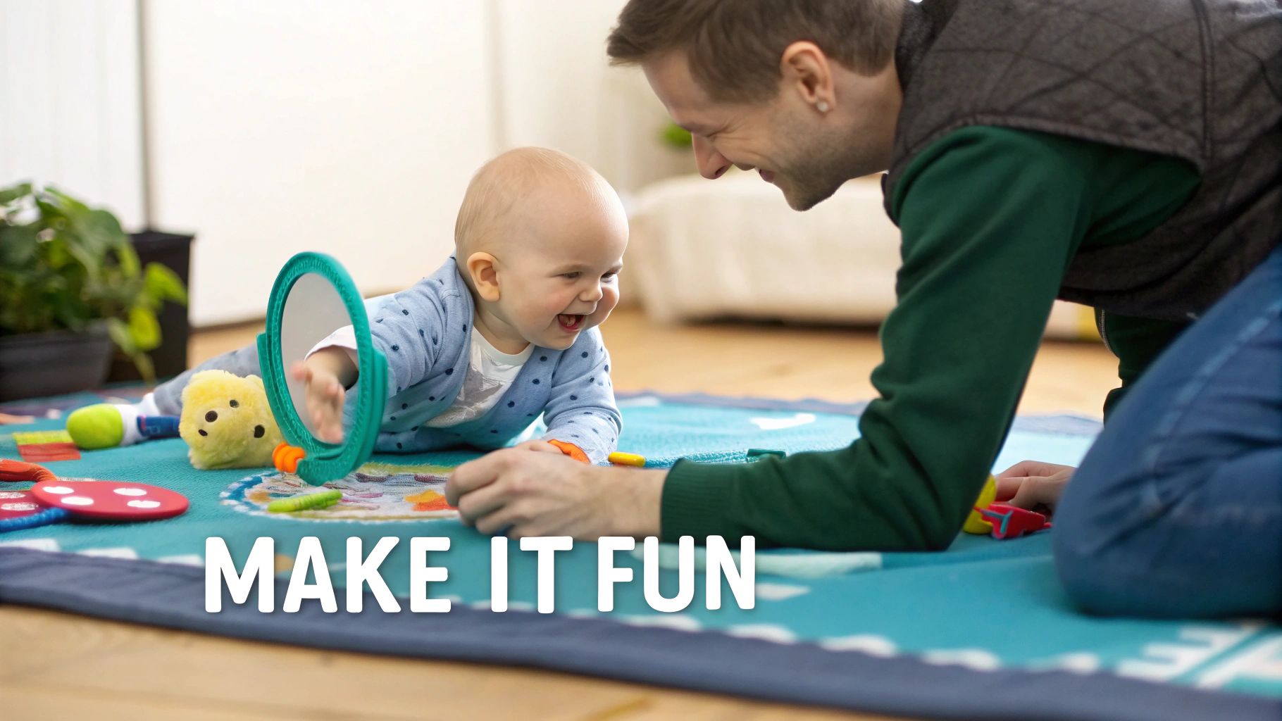 A smiling father engages with his happy baby during tummy time, surrounded by toys on a blue mat.