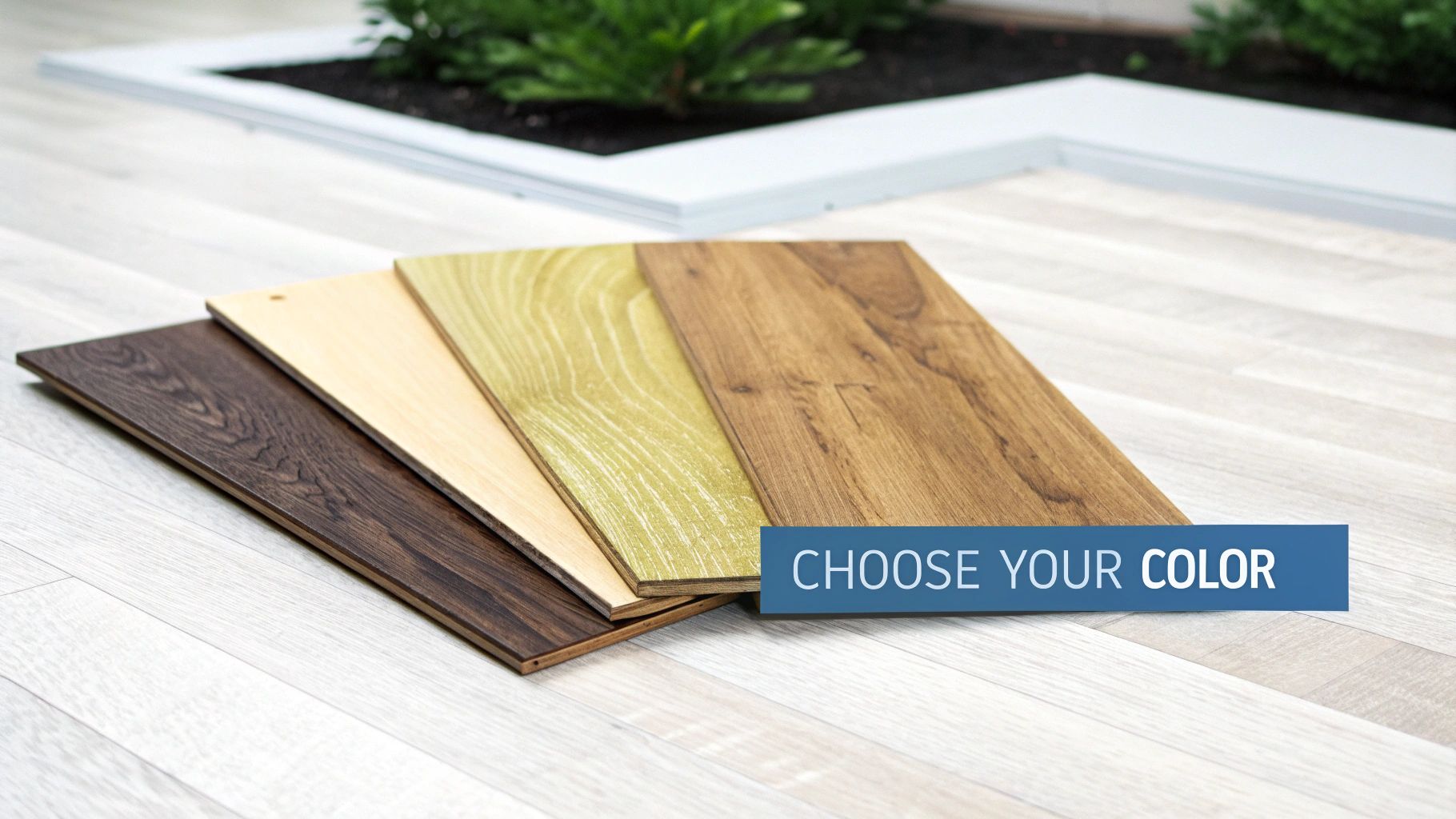 Four varied wood flooring samples, including brown, beige, green, and natural wood, on a light floor.