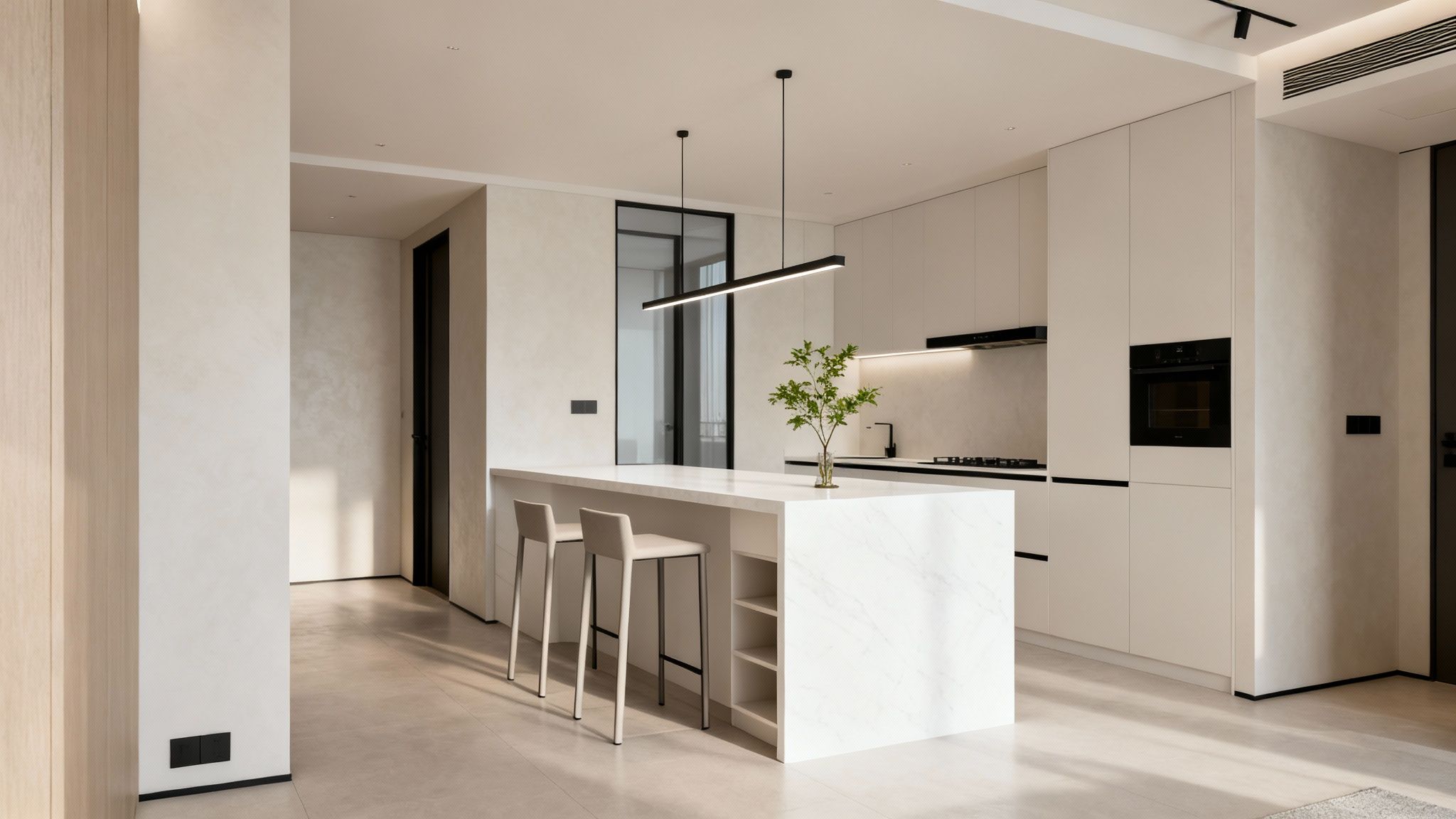 A bright, modern kitchen featuring a white marble island, light cabinetry, and sleek black accents.