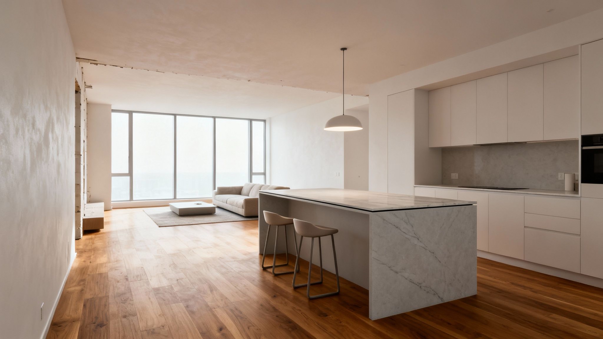 A bright, modern open-concept kitchen and living room with a marble island and large windows.