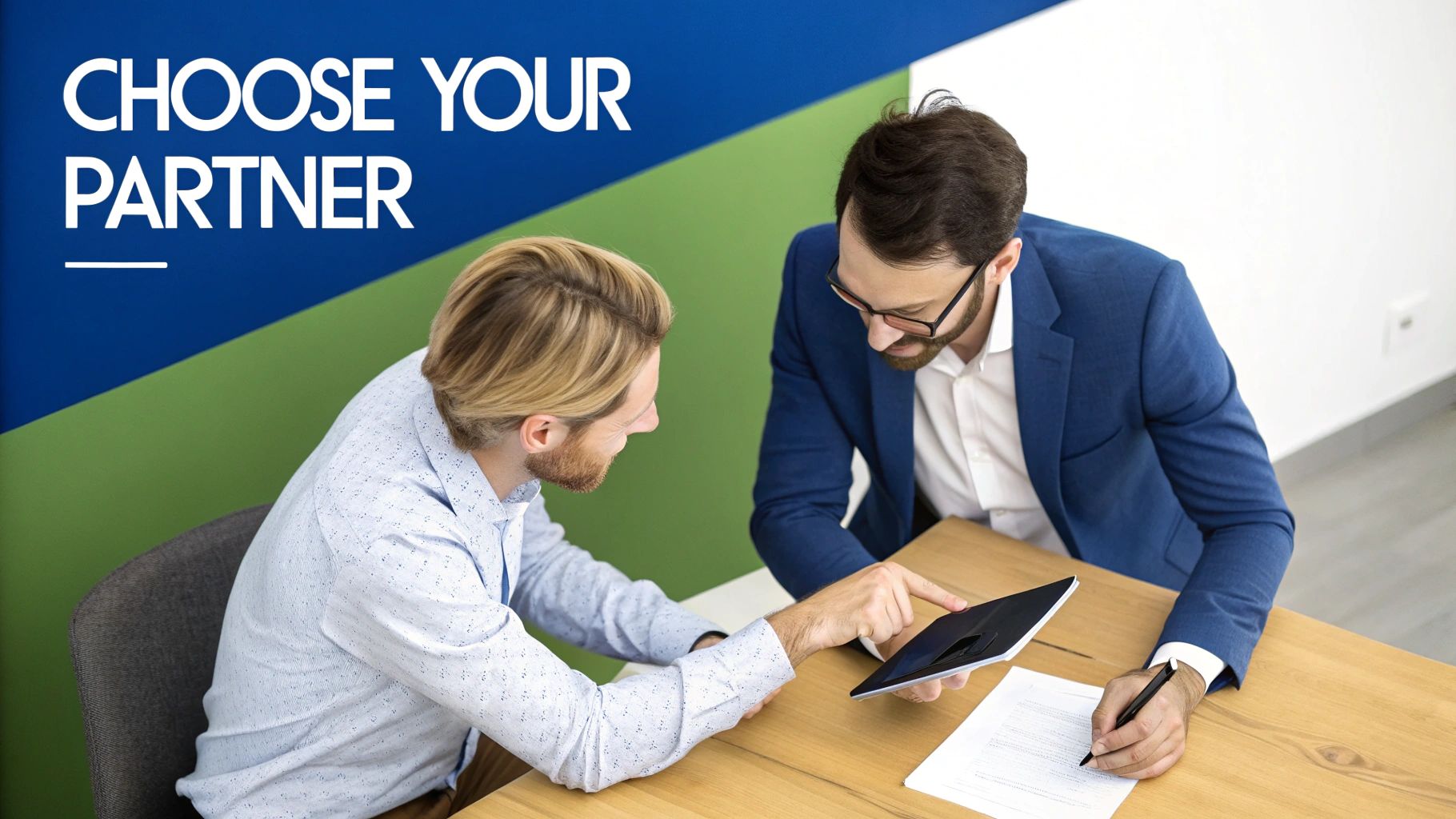 A team of developers collaborating around a desk with monitors showing code and design mockups.