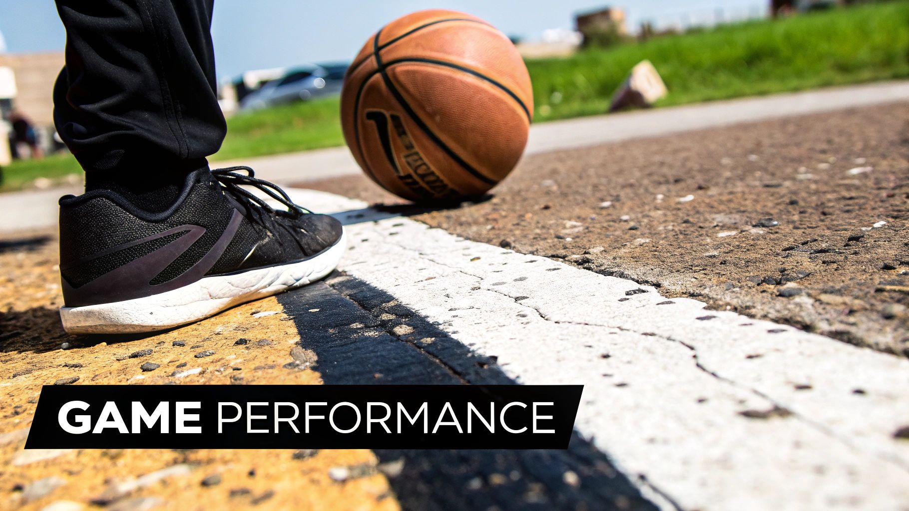 A basketball player dribbling on a professionally coated court.