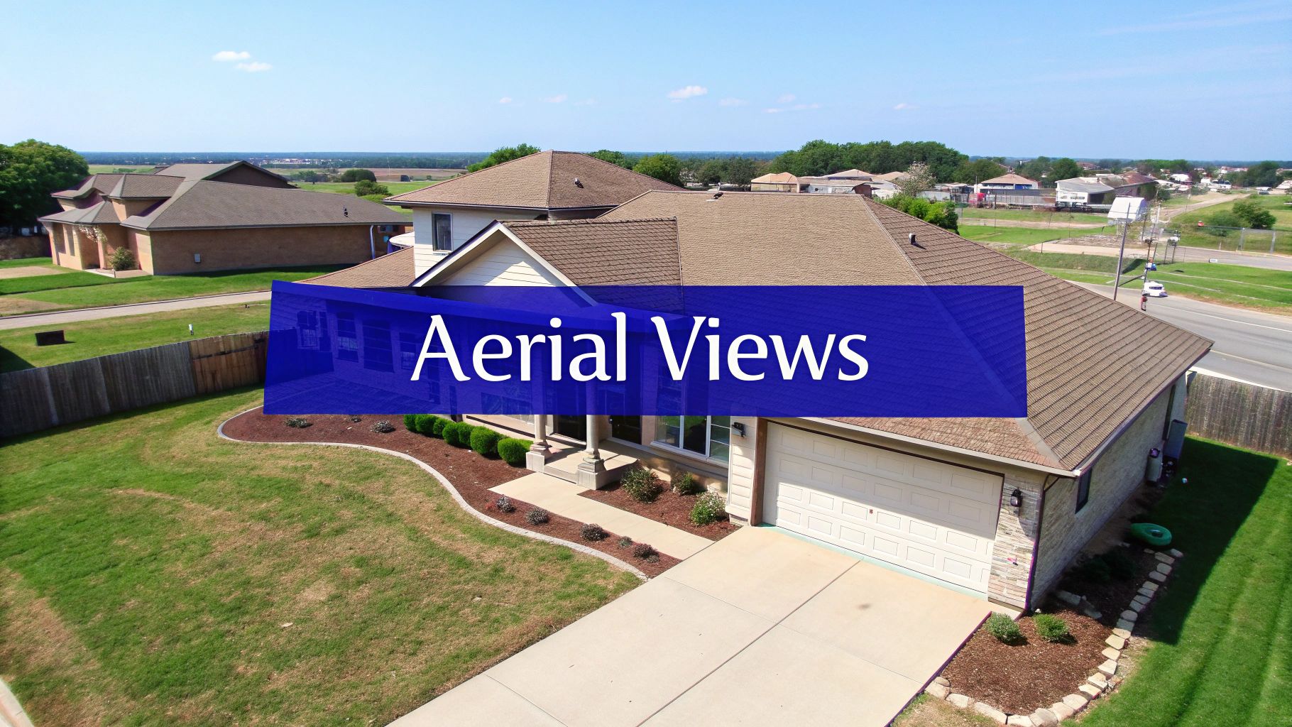 An aerial drone shot of a beautiful home with a pool and lush landscaping