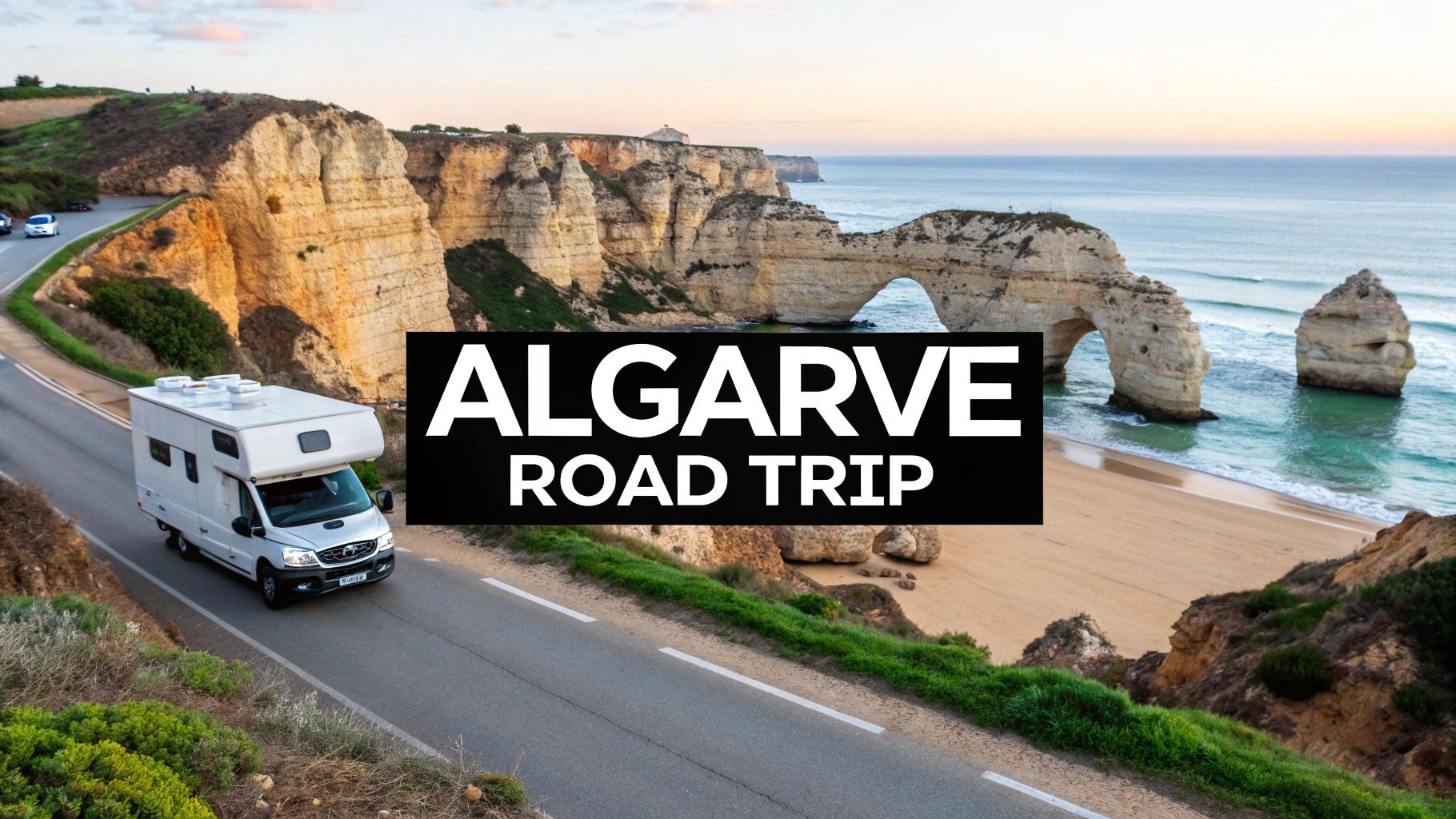 A white campervan drives along a scenic coastal road in Algarve, Portugal, featuring cliffs, a natural arch, and a sandy beach by the ocean.