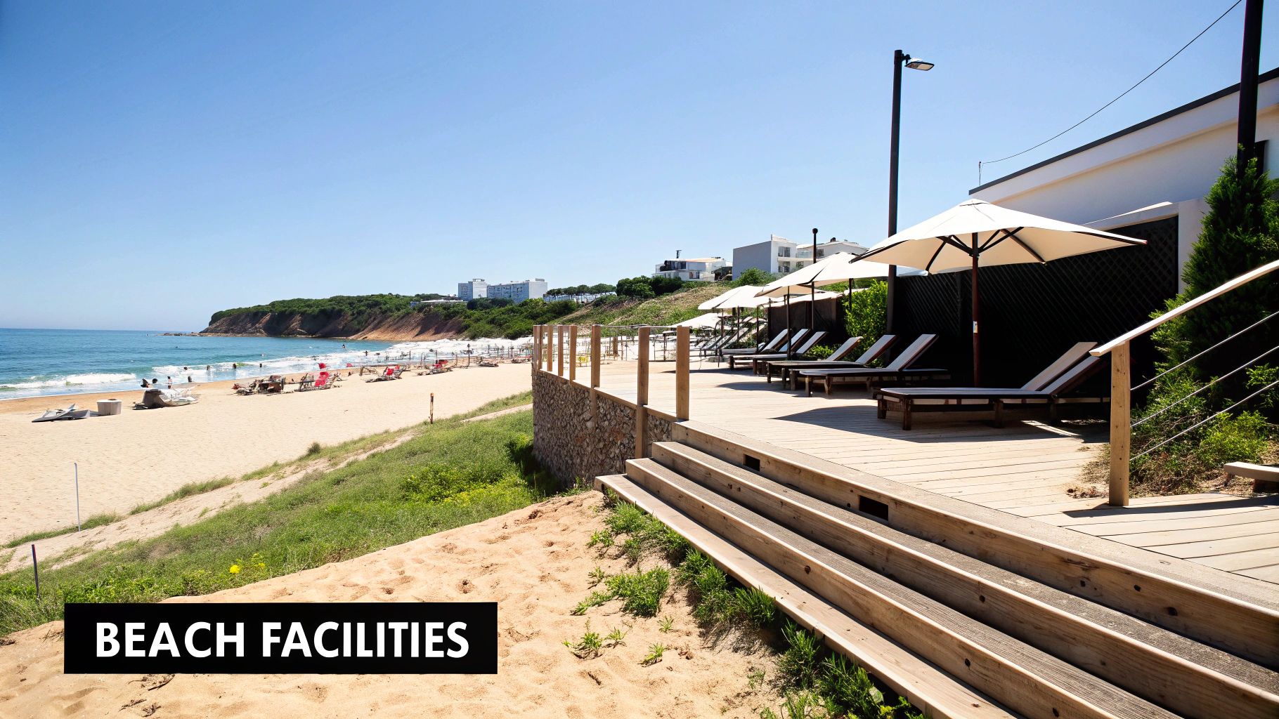 Scenic Coelha beach with a wooden deck, lounge chairs, umbrellas, and people enjoying the sand and sea.