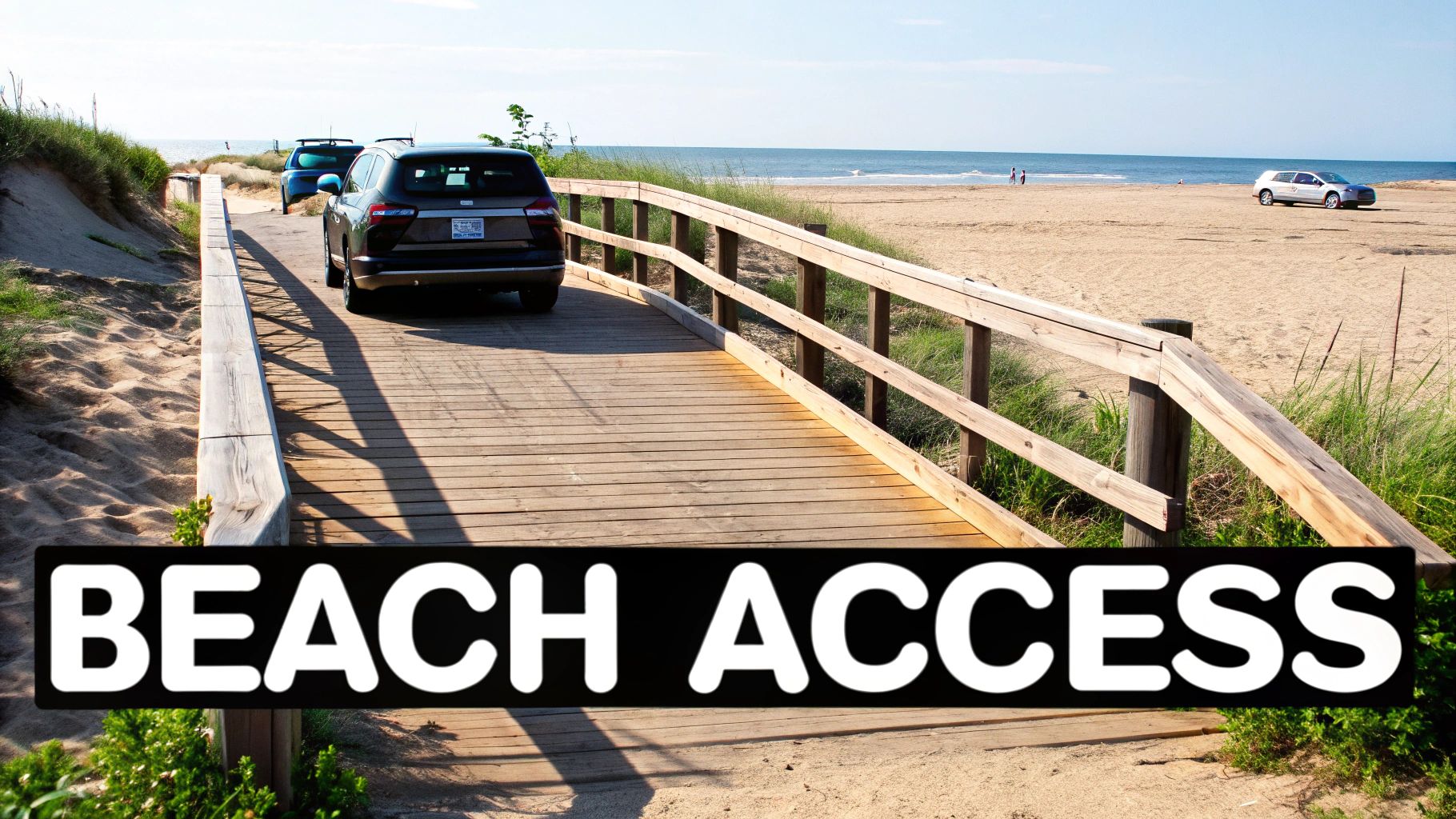 A wooden boardwalk leads to a sandy beach with cars, sand dunes, and the ocean under a clear sky.
