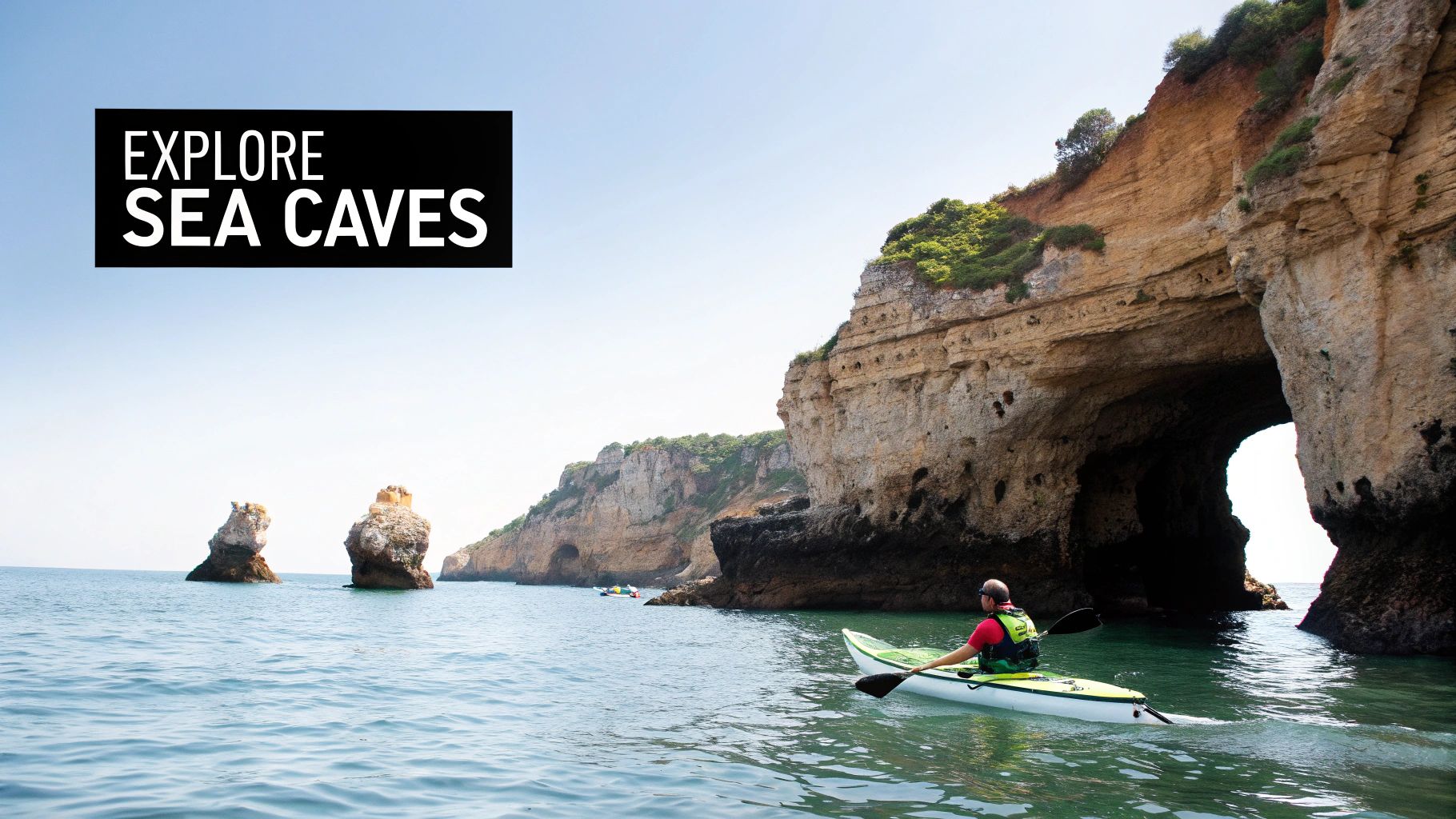 Kayakers exploring the stunning rock formations and sea caves in Lagos, Portugal.