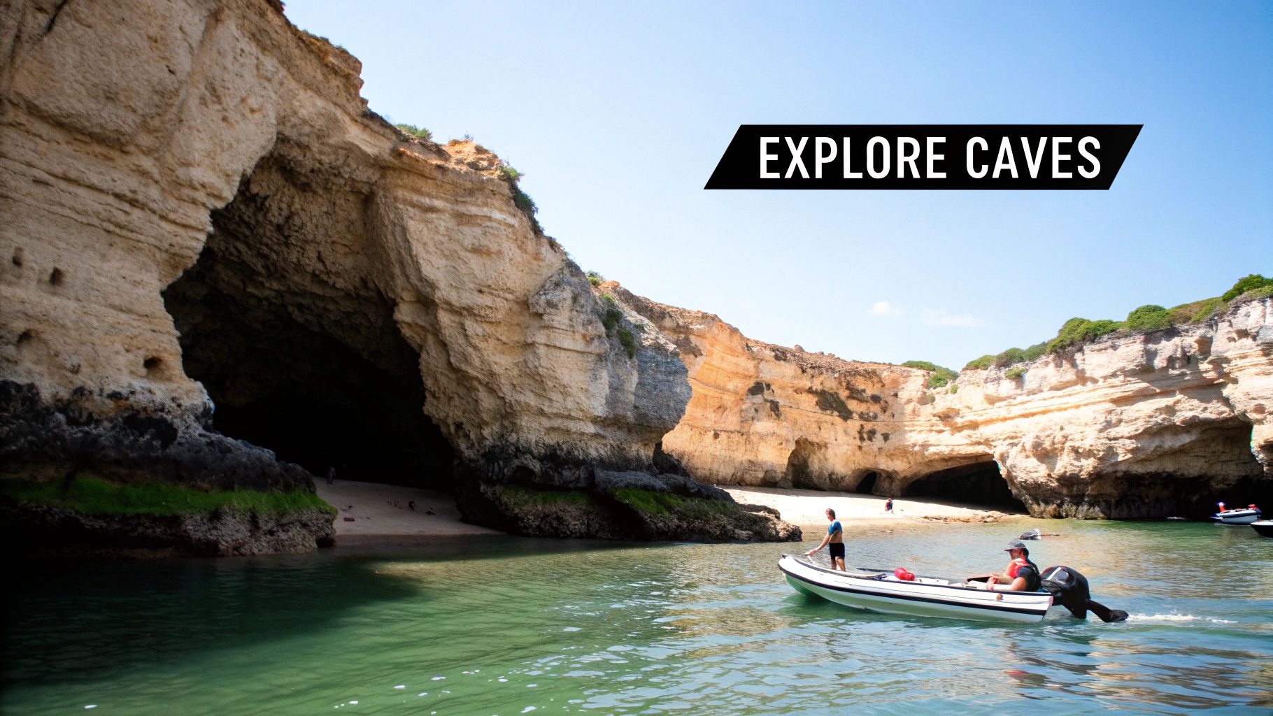 A motorboat with people exploring large sea caves and beaches on a sunny day in the Algarve.