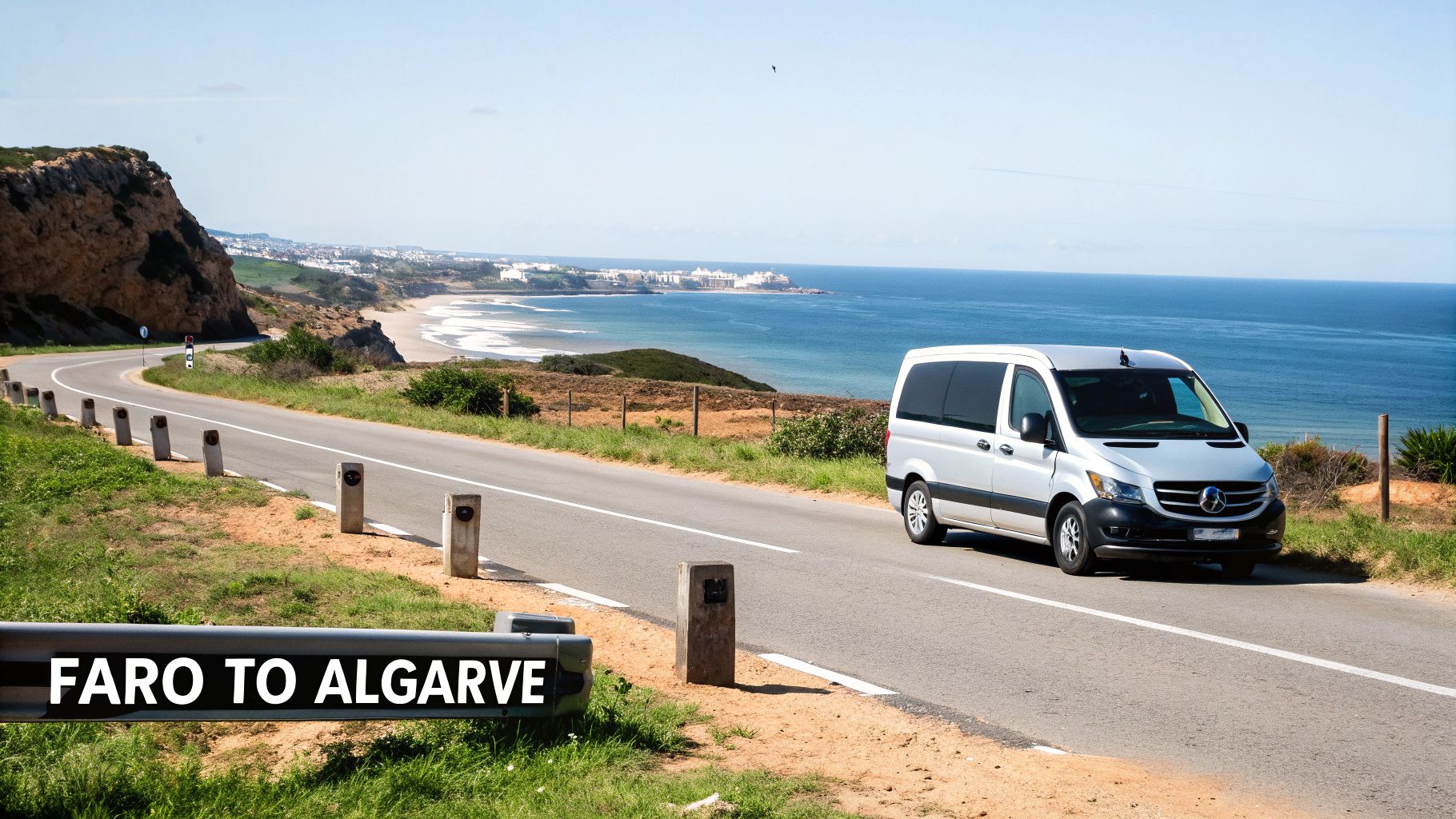 A silver Mercedes van drives along a scenic coastal road in Algarve, overlooking the ocean.