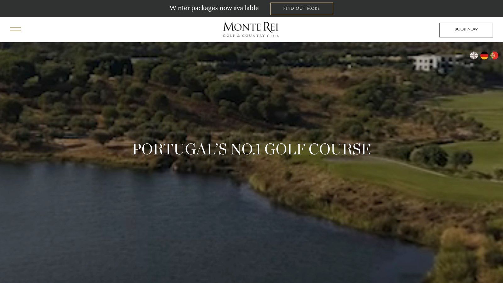 A lush, manicured green at Monte Rei Golf & Country Club, with a water hazard and clubhouse in the background.