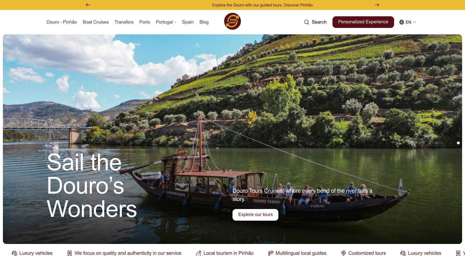 A scenic view from the Douro Tours website, showing a Rabelo boat on the Douro River surrounded by terraced vineyards.