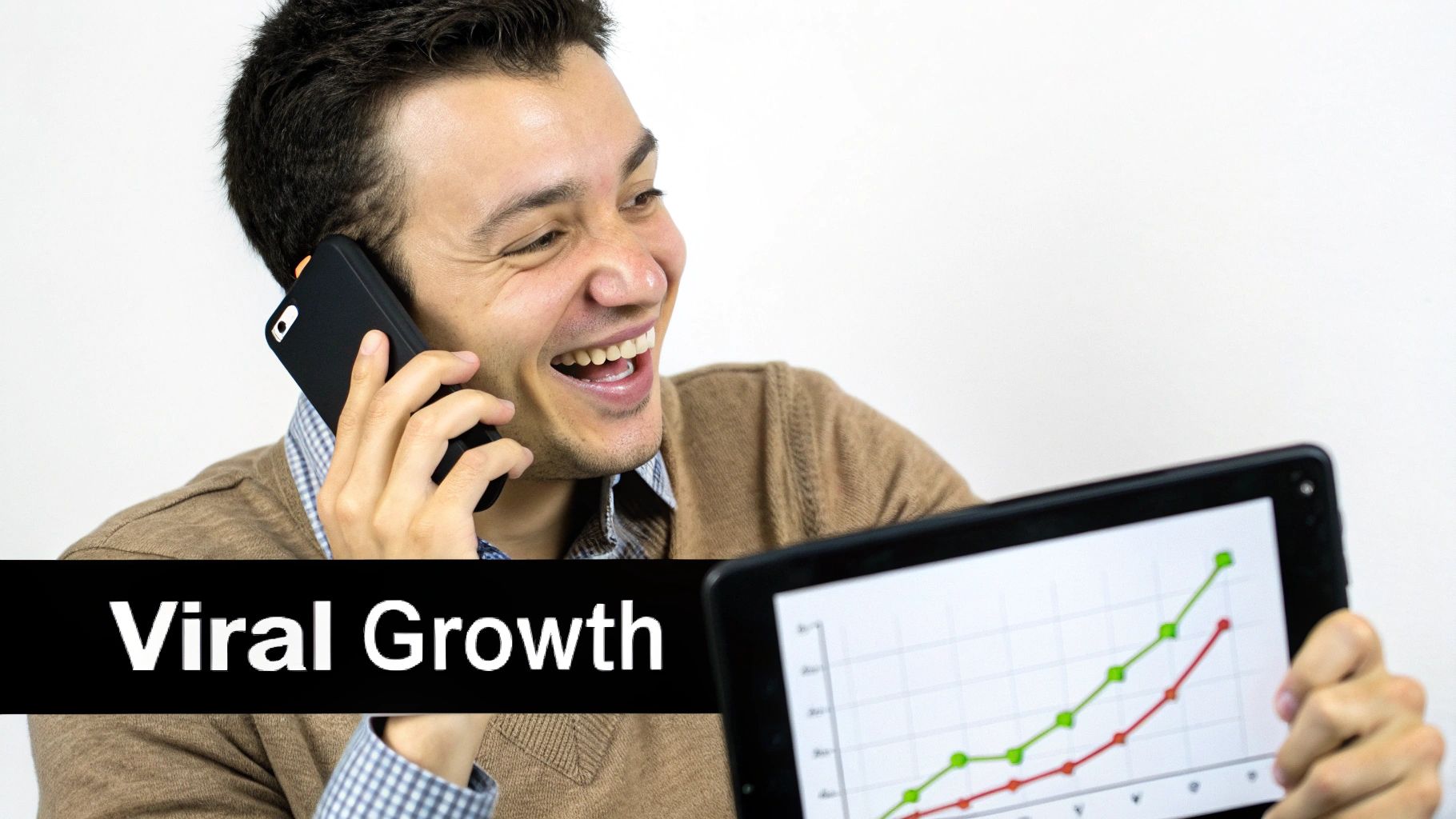 A happy man talking on the phone while looking at a tablet displaying a 'Viral Growth' chart.