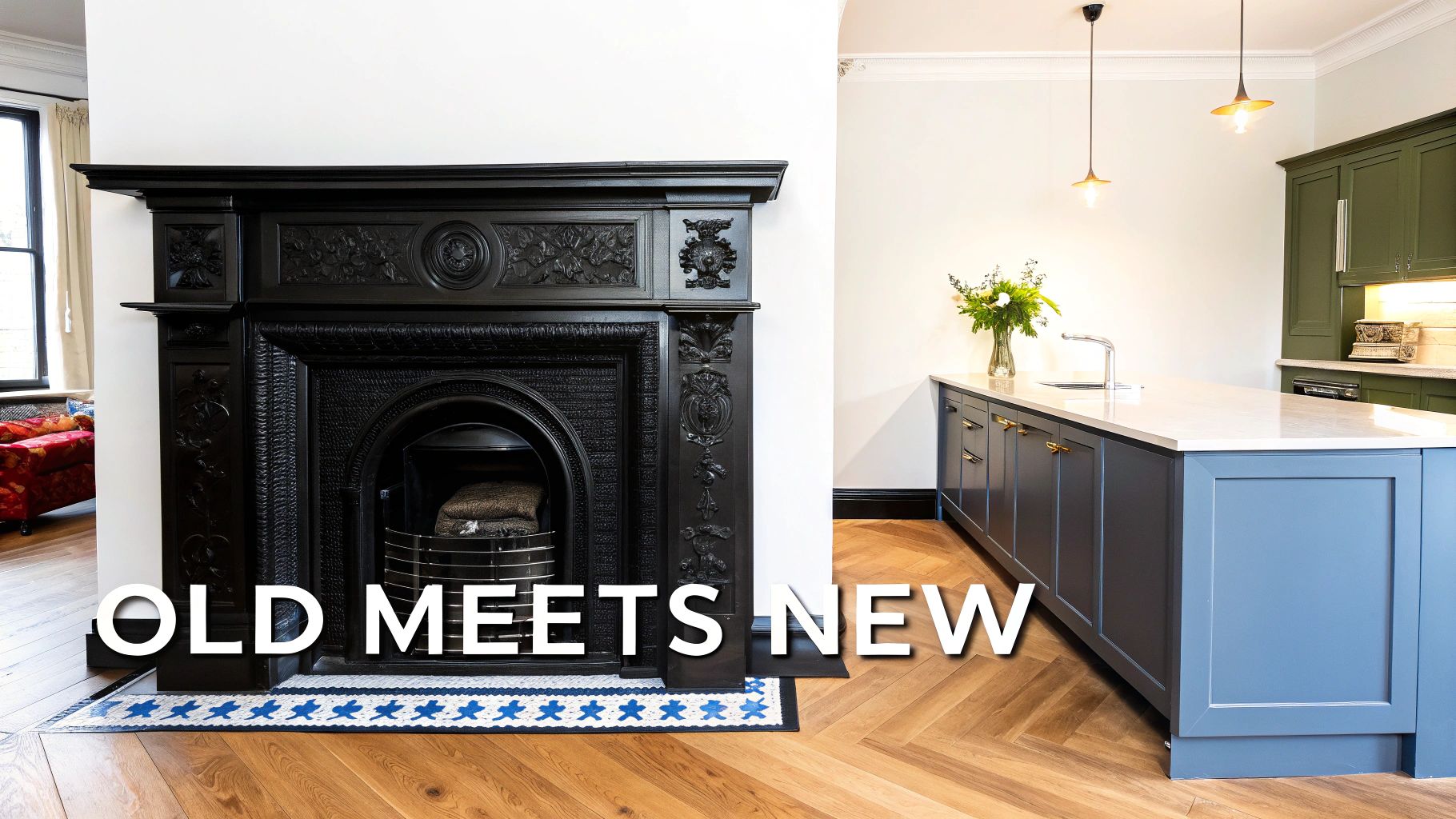 A beautifully renovated room featuring a classic black Victorian fireplace and a contemporary kitchen island with blue cabinets.
