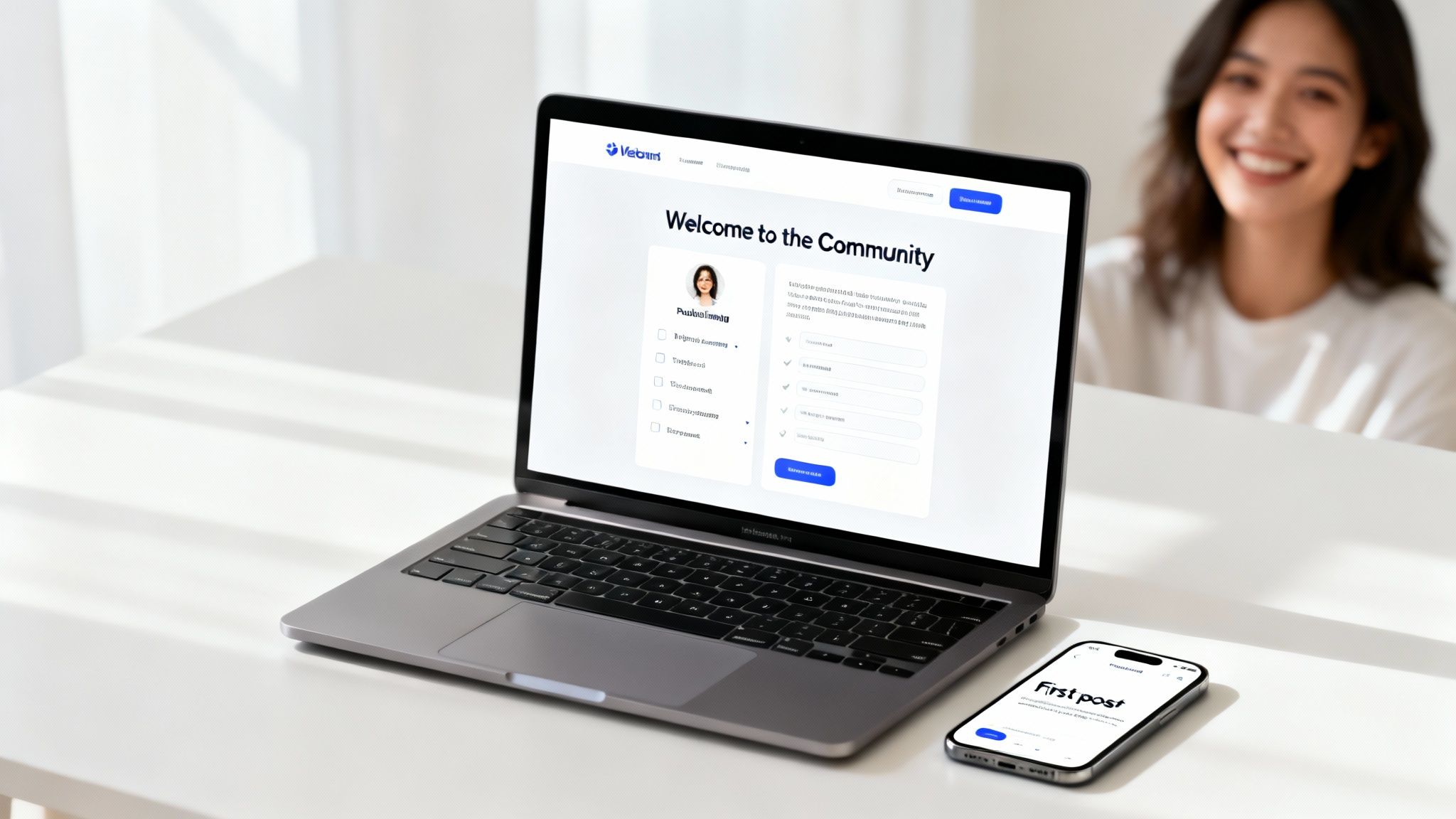 A person smiling behind a laptop showing an online community welcome page and a smartphone with a 'First post'.