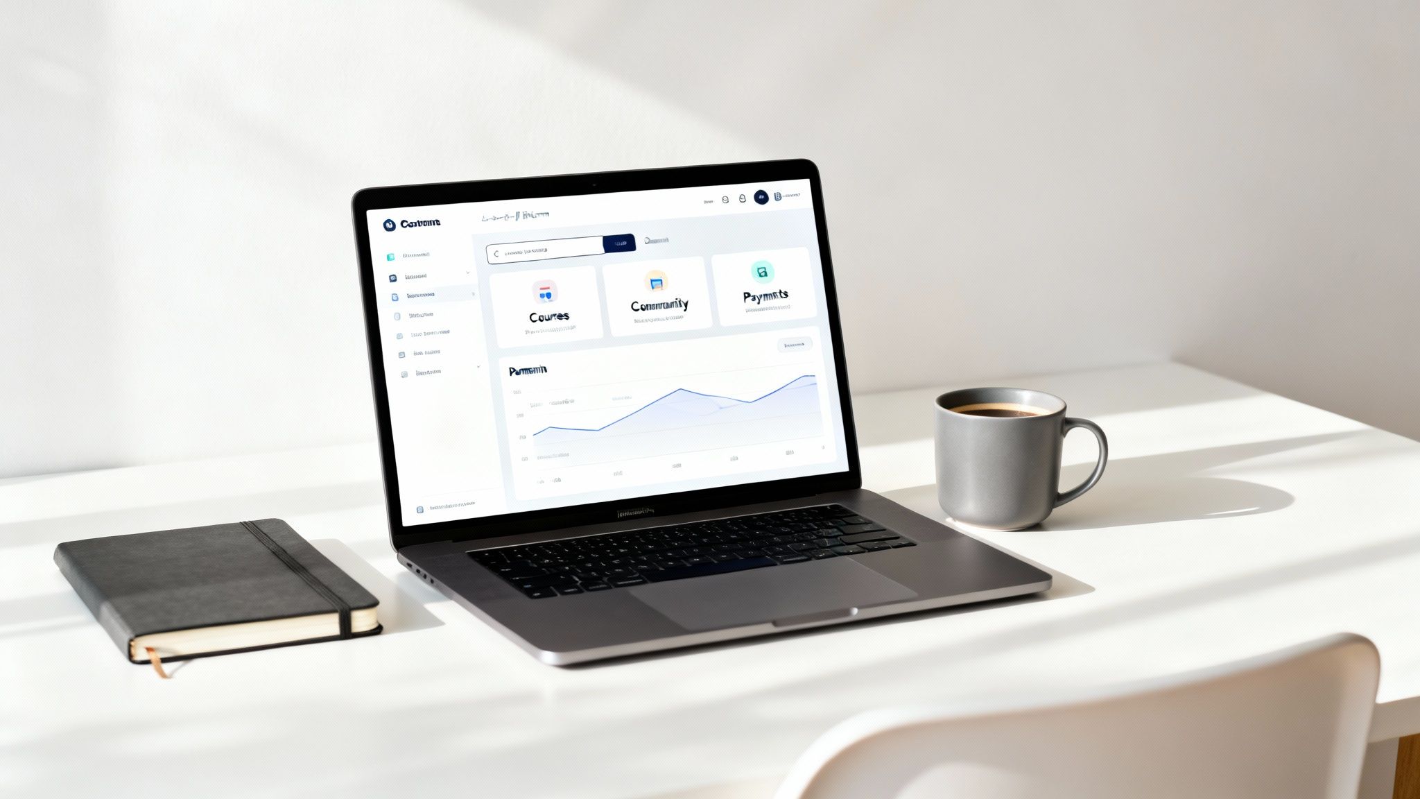 Modern workspace with a laptop displaying a dashboard, a black notebook, and a gray coffee mug.