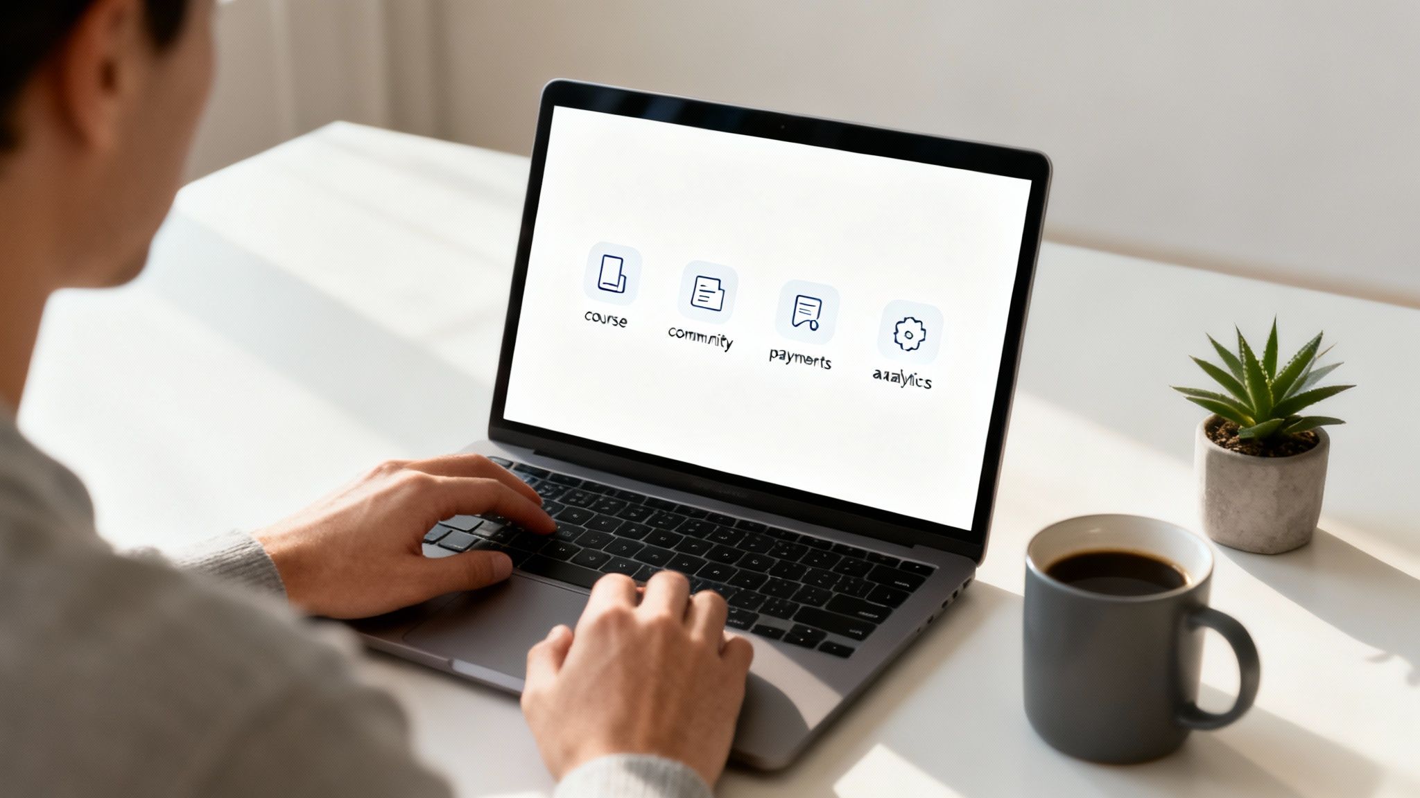 Person typing on a laptop displaying app icons for course, community, payments, and analytics.