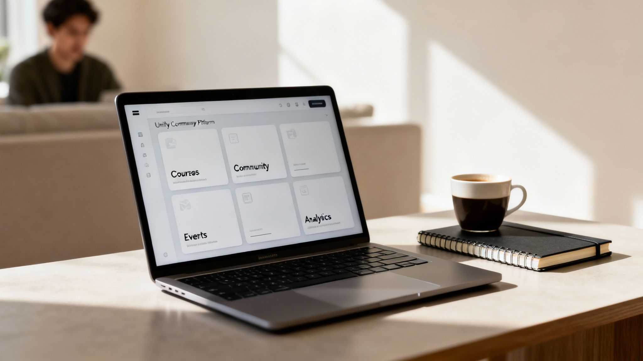 A laptop on a desk displaying a 'Unity Community Platform' dashboard, with a coffee cup and notebook nearby.