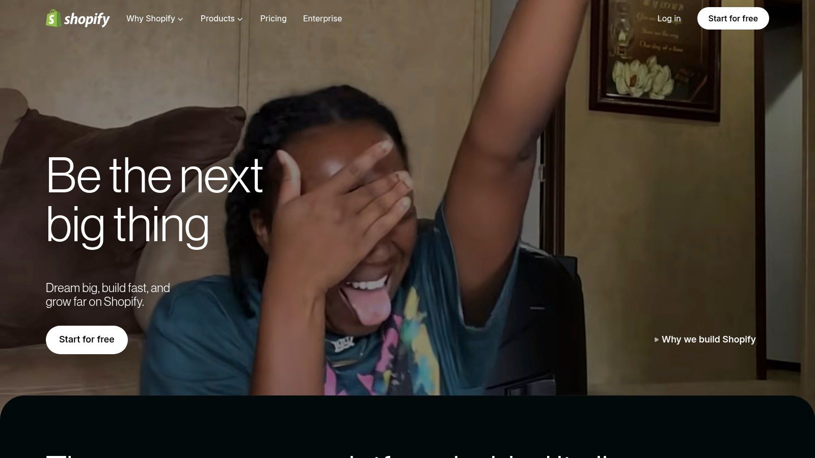 A woman smiles while holding a Shopify-branded package, indicating a successful e-commerce transaction.