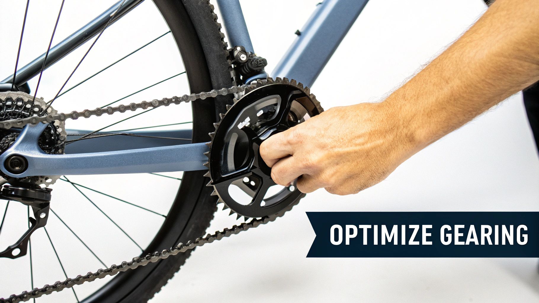 A person's hand adjusts the front chainring of a bicycle, optimizing its gearing.