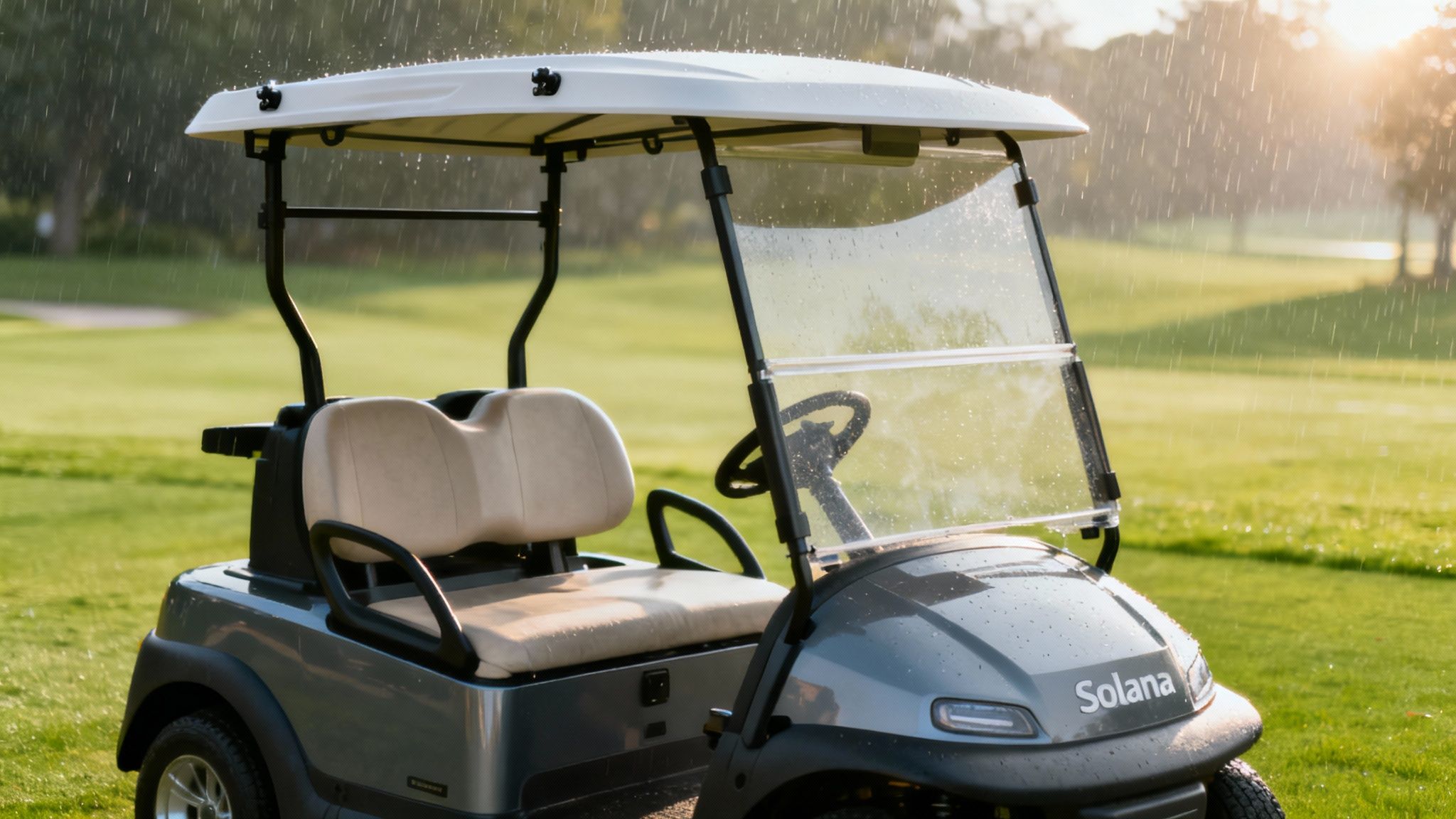 A grey Solana golf cart with beige seats on a golf course during a sunny rain shower.