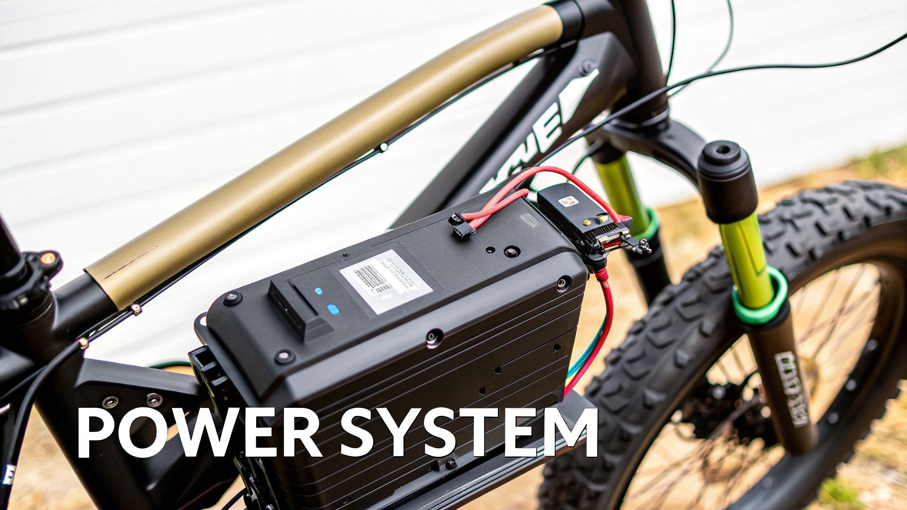 Close-up of an electric bicycle's power system, showing the battery pack and wiring mounted on the frame.