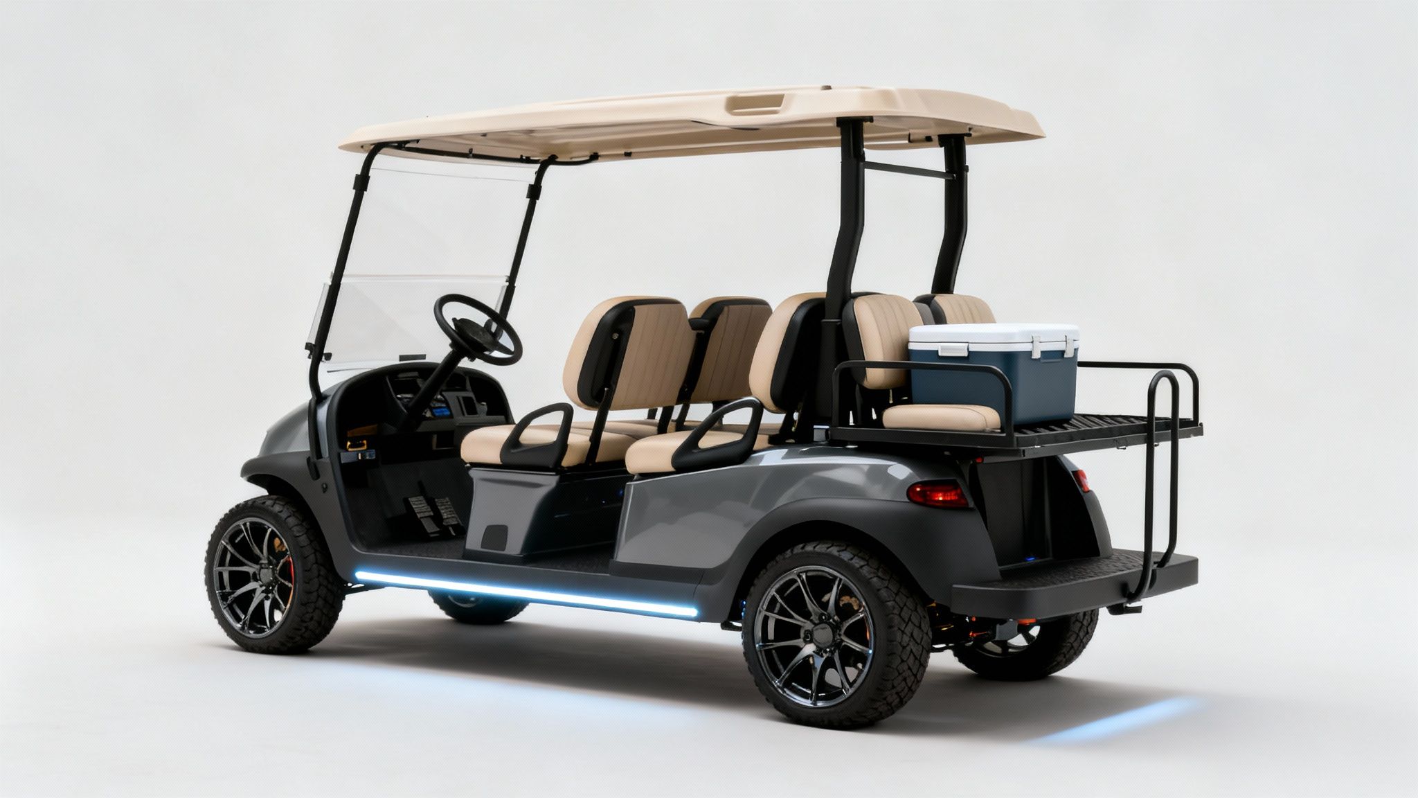 A stylish grey four-seater electric golf cart with tan seats, custom wheels, and a cooler.