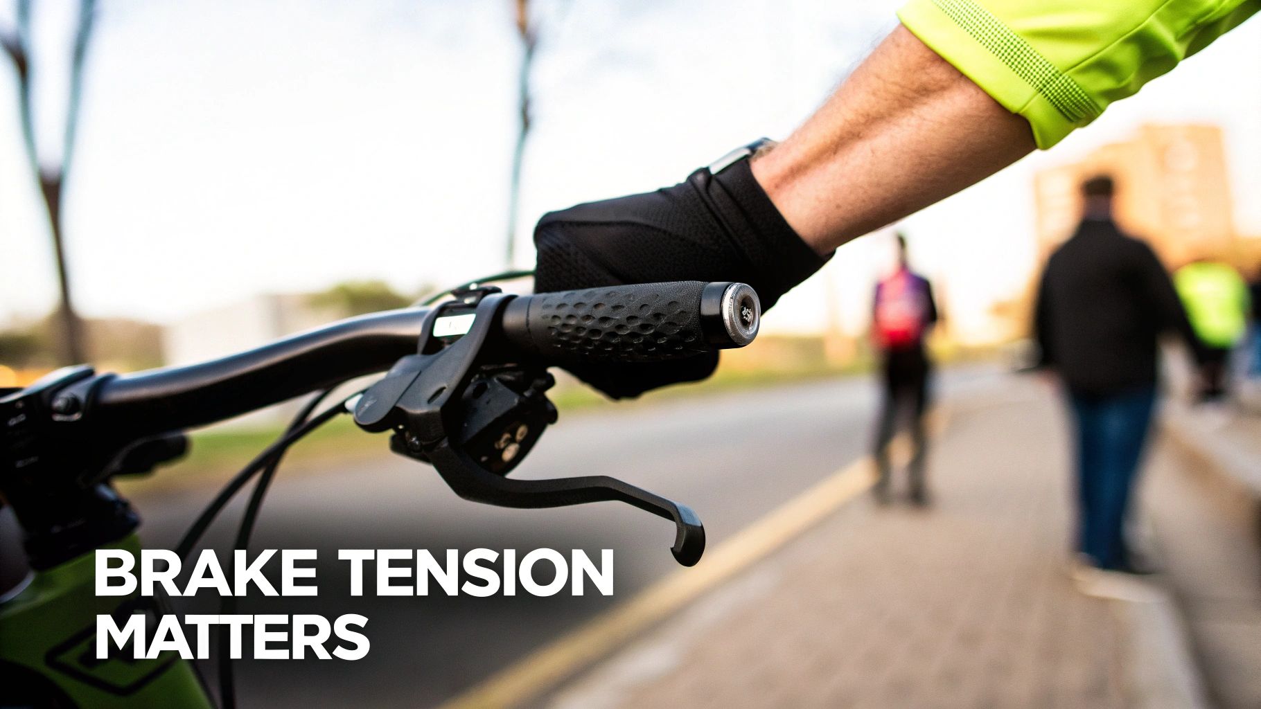 A cyclist's gloved hand on a bicycle handlebar, highlighting the brake lever, with text 'BRAKE TENSION MATTERS'.
